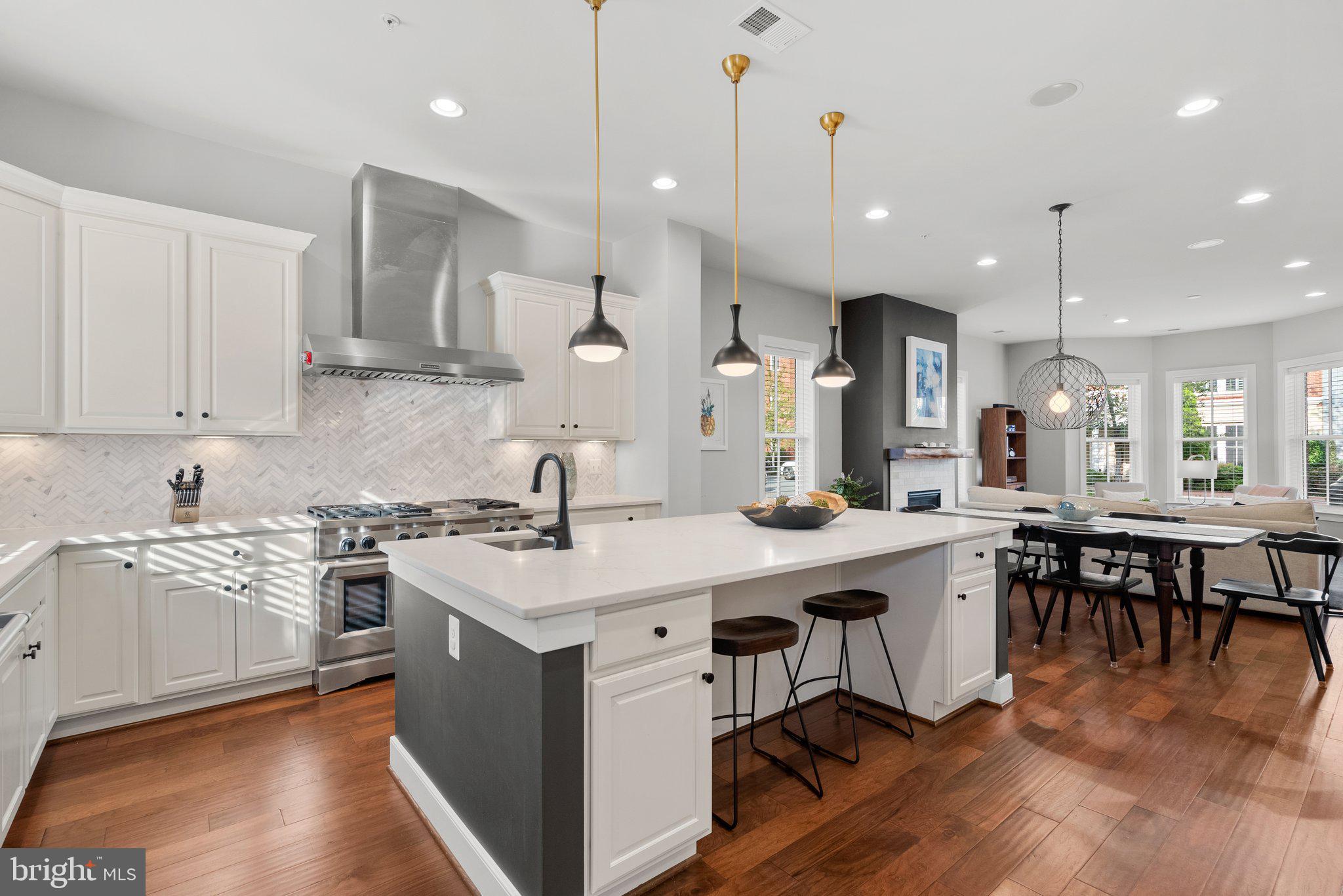 This is the home you've been waiting for!! With over 4,000 sq ft of luxury living at every turn! This 5 bed 4.5 bath End unit townhome in Potomac Yard is truly one of a kind! Upon entering the front door, you are greeted with cascading hardwood floors that lead to an open-concept living area. The main level is adorned with 10’ ceilings, large windows that let in plenty of natural light, and a newly refaced cozy fireplace with a live wood edge and marble surround that adds a touch of warmth and elegance to the space.
With over $200k in upgrades, you will be hard pressed to find any other home in this neighborhood nearly as refined as this one! See full list of upgrades in the documents section.  Kitchen updated in 2022 to include gorgeous quartz countertops with  marble, chevron tiled, backsplash! The center island boasts 40 sq ft of prep space, with prep sink, built in beverage cooler, and bar seating! Well-appointed mud room located just off the kitchen, includes custom built in shelving in the pantry as well as additional coat closet, all of which takes you to your rear patio oasis! Brand new patio pavers installed 2023,  w/direct gas line to the patio area that makes for far more convenient grilling experiences, or you can hook up your favorite fire feature!! Just beyond your patio is the detached 2 car garage (side loading) w/ample storage and In-Law suite above, giving you and your guests an additional 400 sq ft of living space with it's very own HVAC/Hot water heater, bedroom, full bath and mini-kitchen set up.
Primary suite is complete with custom built-in’s  across both walk-in closets, en-suite that includes a new floating tub, white marble floor/wall tile, frameless shower, new vanity/lighting and even added in additional shelving for more storage! Custom bookshelves added to the 3rd level family room, and built-in surround sound across all 4 levels! Dual HVAC units installed in 2020 and 2021. 4th level rec room w/full wet bar and double-side gas fireplace! Enjoy a multitude of outdoor living spaces, including watching fireworks from your oversized roof deck terrace!  Too many upgrades to list, come see for yourself why you can’t pass up this opportunity to move in to  this turn key home!!
Finally- Location matters. This is a rare opportunity to own the nicest, most upgraded home in all of Potomac Yard, and getting in prior to all the future community  developments is going to be a decision you will be glad you made! Caps/Wizard area in progress to be built by/around 2028,  walk to Potomac Yard Metro Station (now open), Amazon HQ2 and Reagan airport are only a few mins north, and Del Ray is only 4 blocks west- you truly have it all here! Welcome Home!