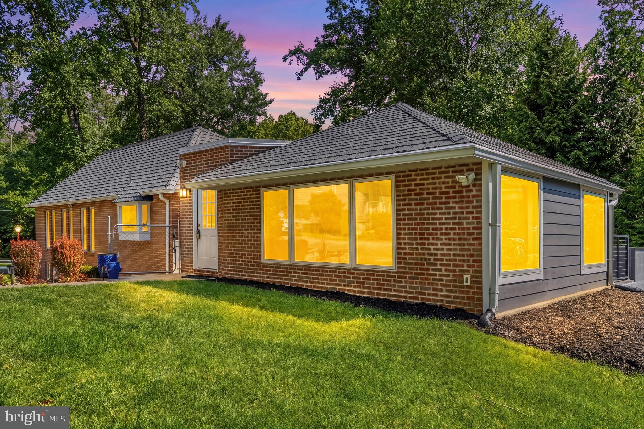 Tucked away on a quiet, tree-lined street just south of Potomac Village, this exceptional contemporary home offers a rare blend of privacy, character, and convenience. Surrounded by mature landscaping and peaceful wooded views, the property feels like a private retreat while remaining just minutes from shopping, dining, parks, and everyday amenities.

Filled with timeless mid-century modern vibes, the home is designed to bring the outdoors in. The dramatic main-level living and dining spaces feature soaring vaulted ceilings and an impressive wall of windows that frame the surrounding greenery and flood the home with natural light. Multiple sliding glass doors open to expansive decks and outdoor entertaining areas, creating a seamless connection between indoor and outdoor living. A striking slate fireplace serves as the focal point of the spacious living and dining areas, adding warmth and architectural character.

The heart of the home is the gourmet kitchen, featuring a large center island, quartz countertops, abundant cabinetry, a pantry cabinet, and a separate staging pantry with space for a second refrigerator. An additional breakfast nook provides a casual dining area and overlooks the beautiful natural surroundings.

A thoughtfully converted garage now serves as an expansive great room, complete with a mini-split system for year-round comfort, creating an ideal space for entertaining, relaxing, or gathering with family and friends. A side entrance provides convenient access to the private driveway with parking for multiple vehicles.

The main level also features a spacious primary suite with a large walk-in closet and an attached full bath, offering the convenience of main-level living. The fully finished walkout lower level expands the living space with a second family room, three additional bedrooms, two updated full bathrooms, ample storage, a laundry/workshop area, and direct access to the private backyard.

Outdoor living is equally impressive, with multiple decks, peaceful wooded views, and a dedicated vegetable garden, providing endless opportunities to enjoy nature and entertain outdoors.

Lovingly maintained and full of personality, this is far from a cookie-cutter home. Whether enjoyed as-is or reimagined to suit your vision, it presents a unique opportunity in one of Potomac's most desirable locations. Just moments from Potomac Village, Great Falls Park, Potomac Swim & Tennis Club, and top-rated schools, this special property offers an unmatched combination of privacy, lifestyle, and potential.