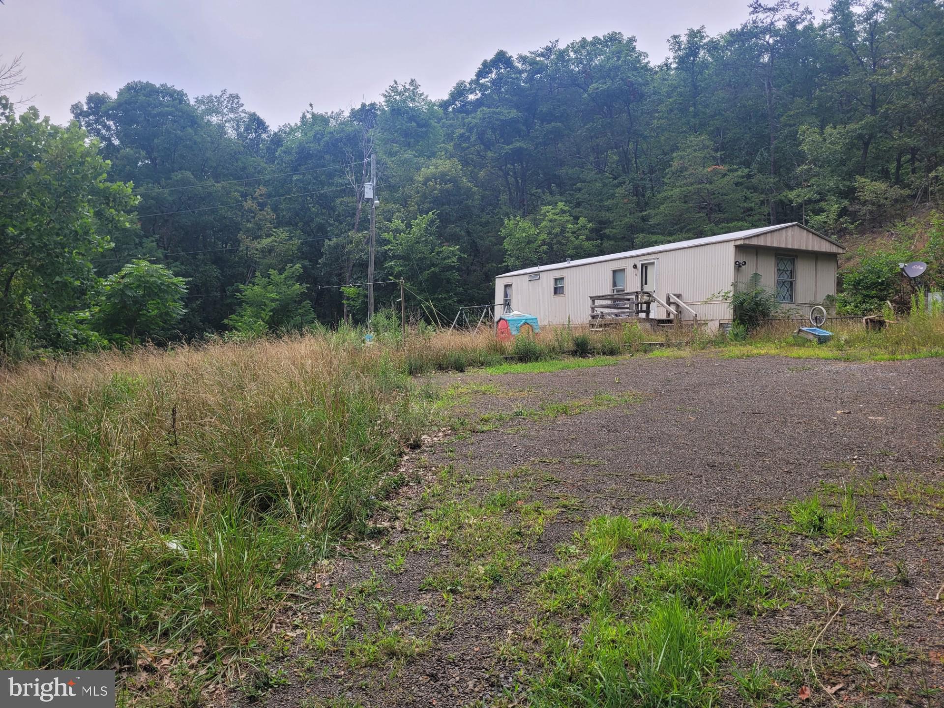 GET THE MOST FOR YOUR $$$$! 62.5 UNRESTRICTED ACRES WITH WELL, MULTIPLE SEPTIC'S, ELECTRIC, AND TONS OF ROAD FRONTAGE ON OLD RT 55 JUST MINUTES FROM MOOREFIELD WV,  RIGHT OFF CORRIDOR H. THIS PROPERTY HAS ABOUT EVERYTHING YOU COULD ASK FOR, IT HAS A DECENT ROAD INTO THE PROPERTY RIGHT OFF OF A STATE MAINTAINED ROAD, IT HAS A YEAR ROUND STREAM THAT REMAINS FLOWING EVEN DURING A DROUGHT, IT HAS MULTIPLE BUILD SITES, SAVE YOURSELF SOME $$$$ ON PERMIT'S,  DRILLING A WELL, INSTALLING A SEPTIC, BUILDING A ROAD, ALL THAT IS ALREADY IN PLACE!!!!! BEST OF ALL, THERE ARE NO RESTRICTIONS, EXCELLENT HUNTING, THERE ARE PLENTY OF TROPHY WHITETAIL'S, TURKEY, BEAR ETC.........THIS PROPERTY WAS ONCE USED AS A SMALL MOBILE HOME PARK, ONE MOBILE HOME IS IN GOOD SHAPE, ANOTHER IS IN DECENT SHAPE, THERE ARE A FEW OTHERS THAT WOULD NEED TORN DOWN OR REMOVED. THE POSSIBILITIES ARE ENDLESS WITH THIS PROPERTY, CALL TODAY, WON"T LAST LONG! JUST 2 HOURS FROM WASHINGTON D.C.!!!!