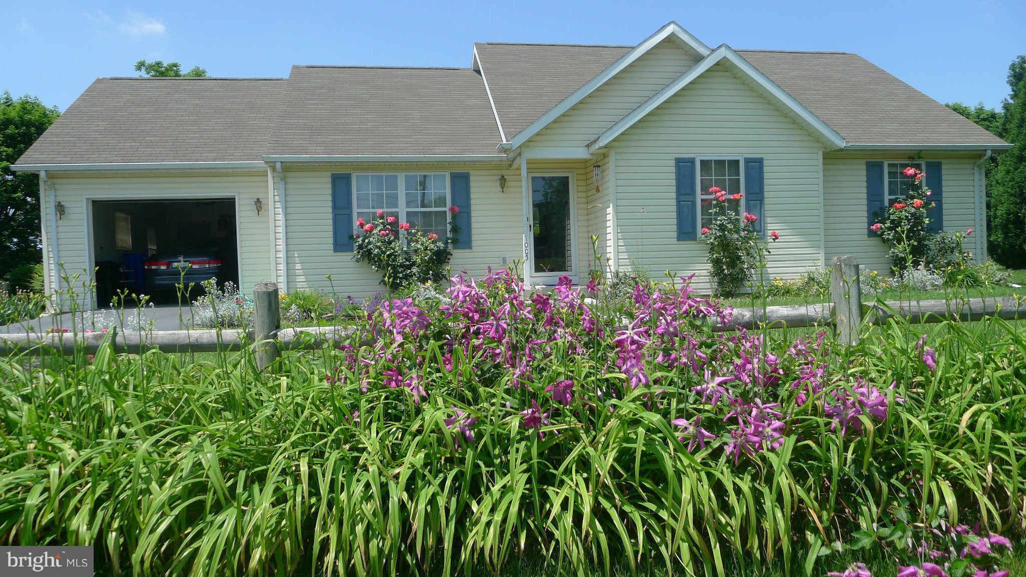 Light filled Rancher surrounded by a bounty of beautiful flowers and shrubs--past owner was an avid gardener.Perfect one level living with some nice amenities - large step in master shower, easy care laminate flooring,  sunroom addition,Workshop attached to garage.Quiet culdesac and close to schools, shopping, MARC, parks.. Sold as is.