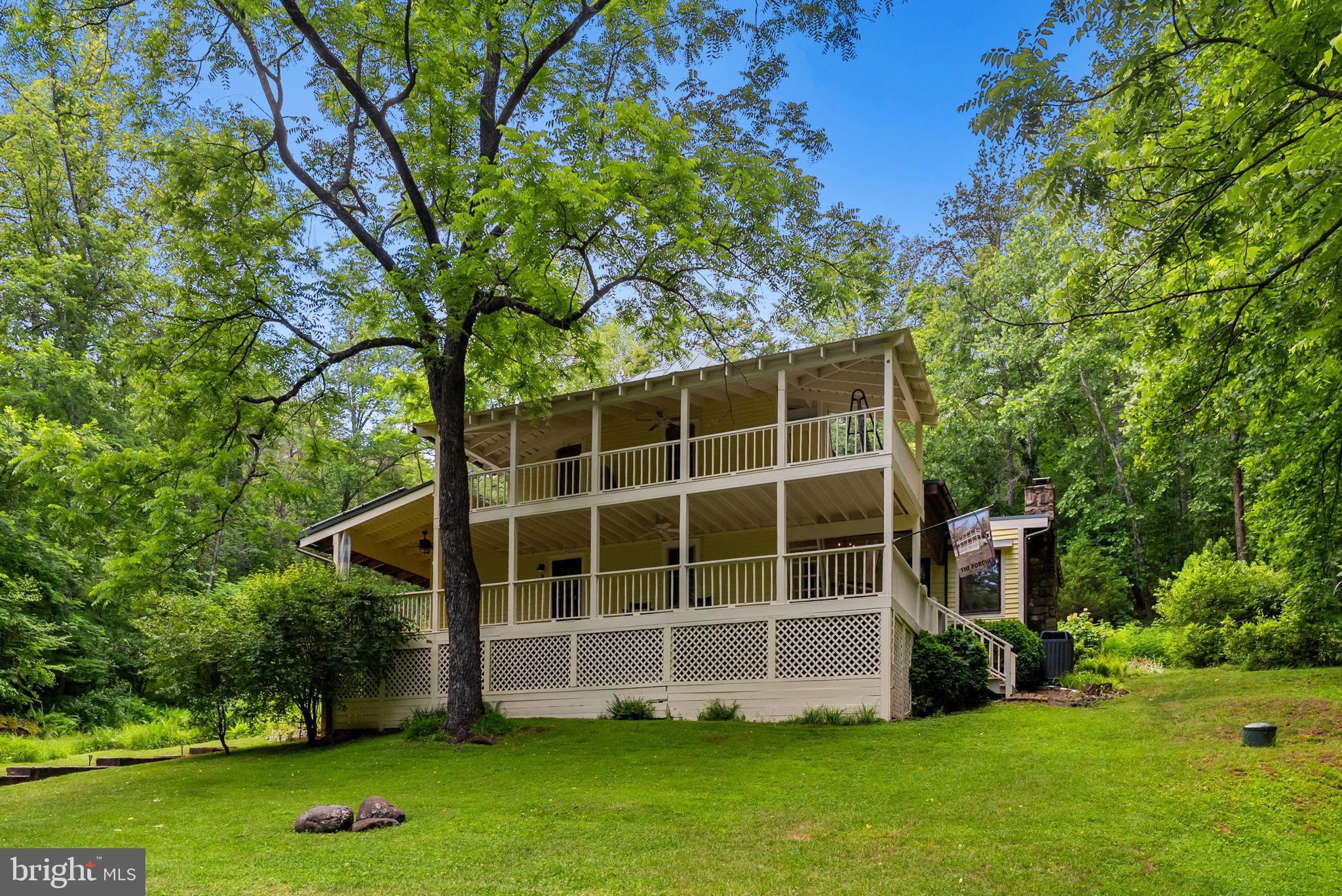 Dreaming of finding a restored, beautifully renovated, newly painted 3-over-3 farm house in the perfect country location? "The Porches" answers your dream! Gracious, expanded, 1910 farm house with termite resistant chestnut framing timber, metal roof, and solar panels is in an idyllic setting on 15 acres with a small finger of the Little Blackwater Creek passing through the edge of the property. Everything about "The Porches" makes you want to rush home. Large Pella double-pane casement windows throughout the house fill it with natural light. Hardwood floors & a centerpiece stone fireplace with a mantle adds to the country ambience. A well-crafted cook's kitchen with granite countertops, 4-burner gas stove, and stainless appliances, provides inspiration for the family chef. Gracious large open great room + sitting room can accommodate a crowd. Enjoy the separate formal dining room with a pass-through to the kitchen for easy serving.  There are  3-bedrooms and two bathrooms. One bathroom is totally new with a no-lip oversized shower, the other has a newly reglazed tub for your soaking pleasure. A library or 3rd Bedroom is on the main floor along with a corner office. Two very large verandas offer the perfect spot to read, entertain, or watch nature. Trails throughout the property lead to the Little Blackwater Creek overlook where a hammock awaits your afternoon attendance for a  delightful siesta. Native plantings are throughout plus a garden to cultivate your own farm-to-table feast. Private setting amidst large farms. Near Shenandoah National Park, Old Rag Mountain, and halfway between charming Sperryville and Old Town Culpeper where a train awaits those needing to be in DC.