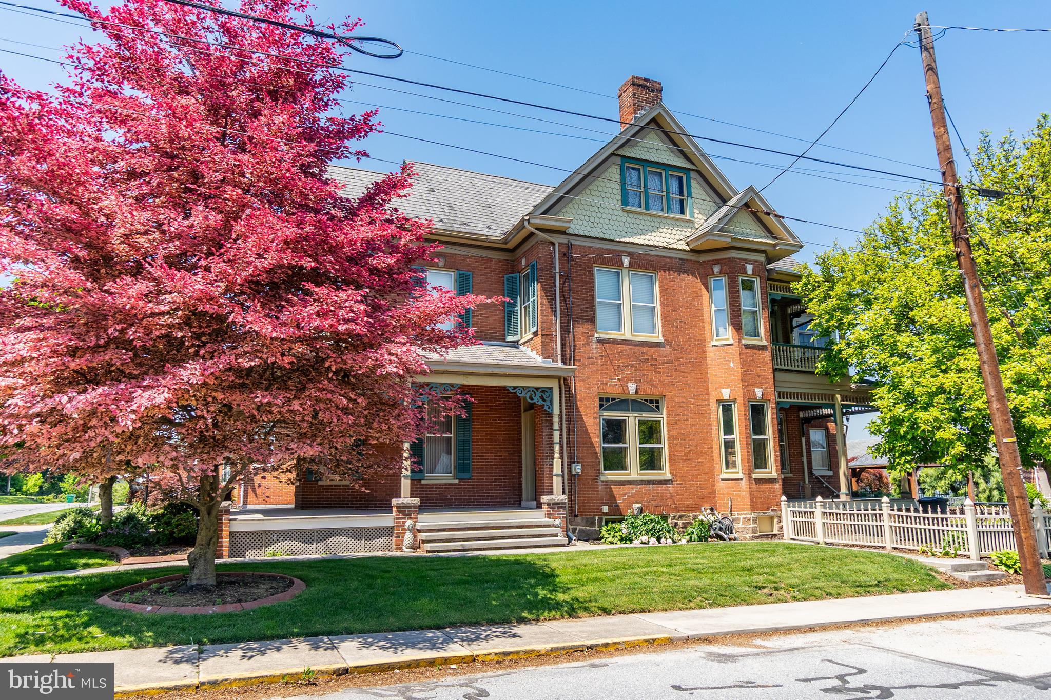 Say hello to your forever home.  This stately brick home has over 3,000 square feet of finished living space and a backyard that dreams are made of.  Built in 1899 by prominent town's person Elmer C Livingston, this home is enriched with history, character, and charm.  The current owners are only the 4th owners, and though over the years updates have been done, they always tried to maintain the original plan of the home.  The wrap around front porch is just the beginning of what this home has to offer.  This home will capture your heart the moment you step inside as you stare up at the soaring 10 foot ceilings and fall in love with the stunning parquet inlay hardwood floors.  The large parlor room could easily be used as an office and the showstopping open staircase is what you would expect to see in a home of this magnificence.  The large living room features a gas fireplace to stay warm on those chilly nights, and the formal dining room is ready for hosting parties.   There is a large mud/laundry combo room giving you an area to leave your shoes at the door and out of the house, there is also a utility sink and extra storage,  The updated kitchen has a large pantry and there is a potential butler's pantry or small office in the adjacent room, if desired.   Upstairs there are 4 bedrooms, with the owner's suite having its own balcony, and all of the bathrooms have also been updated. The full attic and basement give you tons of storage space.  Outback is an entertainer's dream with a bridge over a Koi pond, mature landscaping and gardens, gazebo, and several sitting areas.  2 car carriage house with inside stairs leading to a bonus room.  There is even ample off street parking. This one-of-a-kind home will leave you speechless, except to say, "I'm home!"