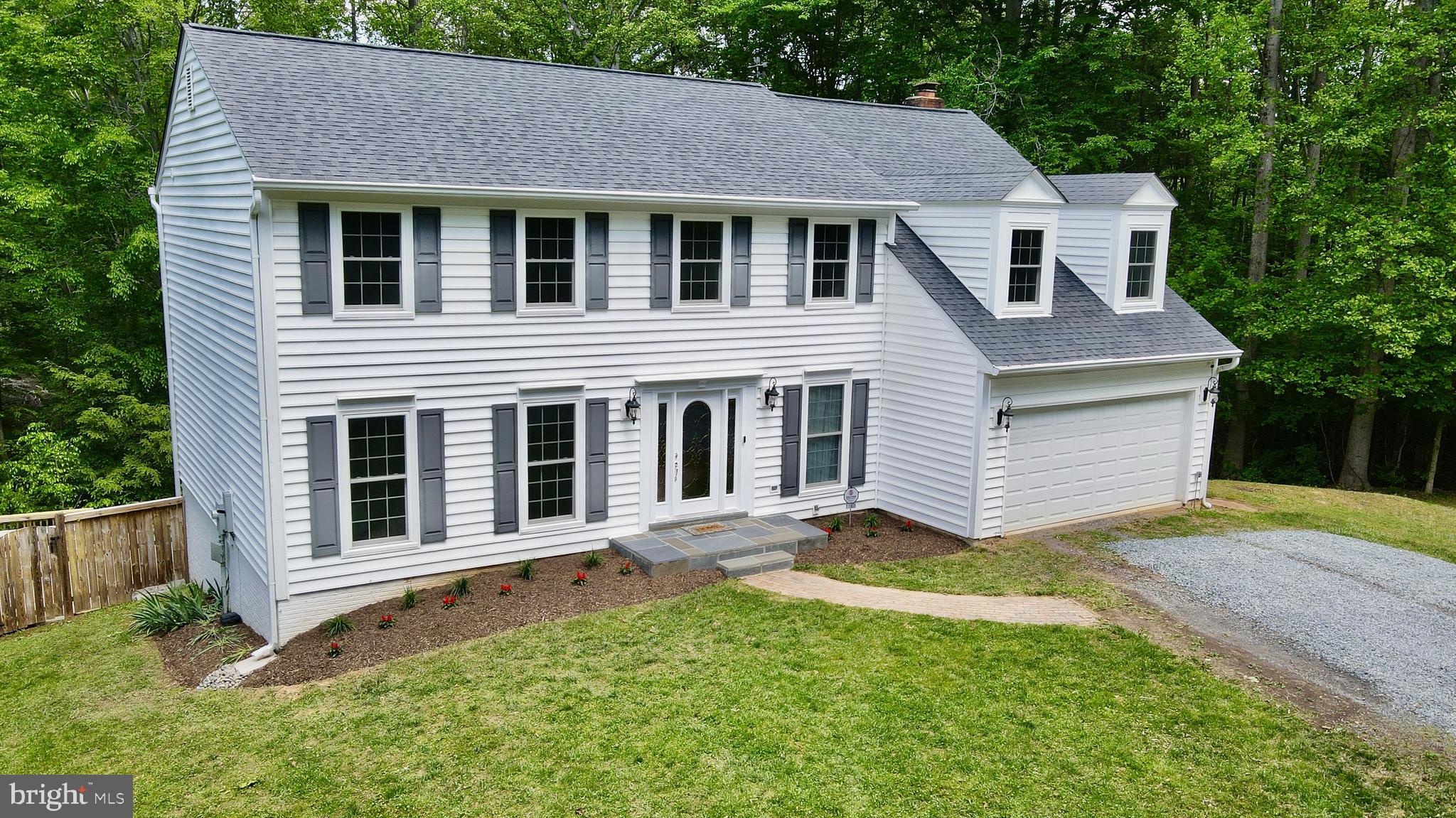 Welcome to 11905 Falling Creek Drive — a rare private retreat nestled on 5.65 acres in the heart of Manassas, offering the perfect blend of privacy, modern updates, and everyday convenience. With no HOA, an in-ground pool, and beautifully updated interior and exterior, this exceptional 4-bedroom, 2.5-bath home delivers the lifestyle buyers are searching for. Offering approximately 3,500 finished square feet across three levels and a 2-car garage, this property sits in a peaceful natural setting. It feels worlds away while remaining close to everything Northern Virginia has to offer.

Inside, the home has been thoughtfully updated with new hardwood floors throughout the main level and a warm, neutral color palette designed to complement any style. The fully remodeled kitchen is both elegant and functional, featuring new shaker cabinets, quartz countertops and backsplash, brass hardware, stainless steel appliances, recessed lighting, a center island with a cooktop, and generous space for gathering with family and friends.

The kitchen flows seamlessly into an inviting family room centered around a brick fireplace with built-in shelves situated on both sides, creating a warm and functional focal point for cool evenings.  Direct access to the rear deck — featuring new boards and railings — creates an easy flow for indoor-outdoor living. The rear deck overlooks the pool and surrounding acreage, creating the perfect space for outdoor dining and entertaining. Large windows throughout the home bring in natural light and showcase serene views of the surrounding landscape.

Upstairs, there are 4 genererious sized bedrooms with the primary suite offerering an adjoining bonus room that can easily serve as a private home office or nursery. Fully refreshed bathrooms, new upper-level carpet, and thoughtful updates throughout create a clean, move-in-ready feel. 

The finished walk-out lower level provides endless possibilities — whether you envision a recreation room, home gym, media space, playroom, or additional entertaining area.

The outdoor setting truly sets this property apart. Enjoy summer days by the private in-ground pool surrounded by mature trees, expansive decking, fencing, and peaceful wooded scenery. The property offers an ideal balance of open usable yard space and wooded privacy, allowing owners to enjoy recreation, gardening, homesteading, entertaining, or quiet retreat-style living.

Major improvements include the roof, siding, windows, water heater, water treatment system, pressure tank, sump pump, attic insulation, fully remodeled kitchen, refreshed bathrooms, new hardwood floors on the main level, new upstairs carpet, fresh paint throughout, and newer deck boards and railings. Conveniently located near the Route 234 / Prince William Parkway corridor with access to I-95, I-66, Route 28, Hoadly Road, VRE options, and major Northern Virginia employment corridors. This exceptional property offers the warmth of a true home with the space, privacy, updates, and setting today’s buyers are searching for.