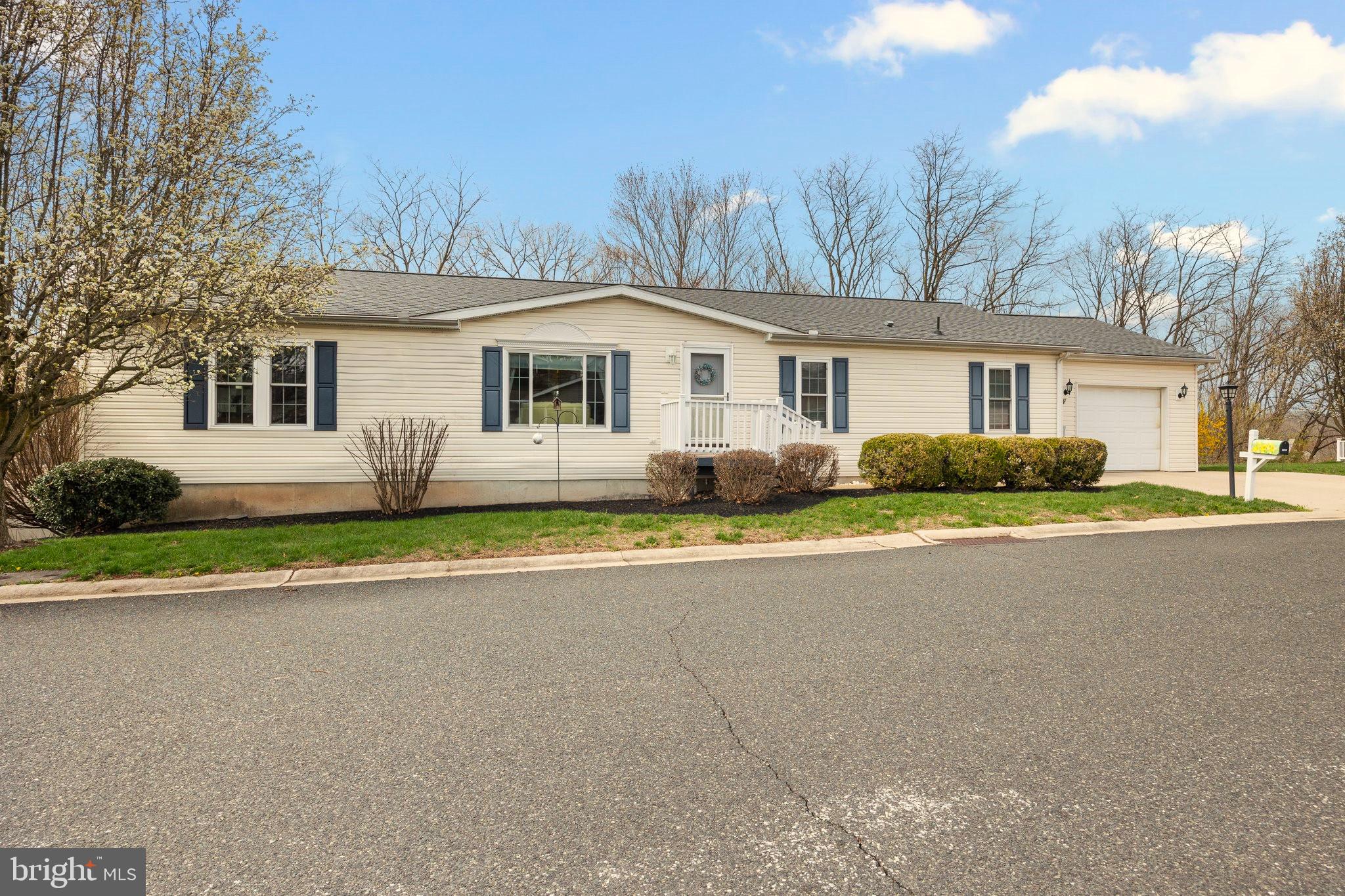 Welcome to Creekwood Village, a quiet senior community tucked away in the rural hills of beautiful Skippack Township. This home features 3 bedrooms, 2 full bathrooms, an oversized 1 car garage and a fabulous bonus of a full finished basement! If you are looking to downsize to one floor living but still need the space for storage and for family gatherings, this home definitely is the answer. As you enter into the cheery living room filled with natural light from the beautiful picture window, you will feel the warmth and comfort of home instantly. The living room leads into the expansive eat-in kitchen with a large center island, corian countertops, double sink, newer dishwasher(2024) and garbage disposal(2023), as well as an abundance of cabinetry to store all of your small appliances. There are sliders that lead out from the kitchen to the huge 40' x 14' rear deck, to enjoy the private and scenic views of all that nature has to offer. Back inside from the deck there is another door that leads into the laundry room, which is located just off the kitchen. There is a cozy family room open to the kitchen with propane gas fireplace and ceiling fan. You can opt to make this room into a dining room to entertain your family and friends, just as the current owner has done. On one side of the home, you have the comfy Owner's suite with a 10' x 5' walk-in closet, ceiling fan and attached spacious bathroom, with a two sink vanity, soaking tub and stall shower. Follow the easy to clean and maintain natural colored laminate flooring throughout, to the opposite side of the home, where you will find two other bedrooms and a full bathroom with tub shower. A spectacular option not offered in every home in this community is the humongous full finished basement with sliding glass doors out to a patio. The roof is only 3 years old, recently installed in 2022 and HVAC in 2017. Most windows and the sliding glass doors to the deck have been replaced. Parking is not a problem with the expanded driveway for two vehicles. Take a stroll down the street and enjoy gathering with your new neighbors at the beautiful pool and clubhouse. Make your showing appointment today!
