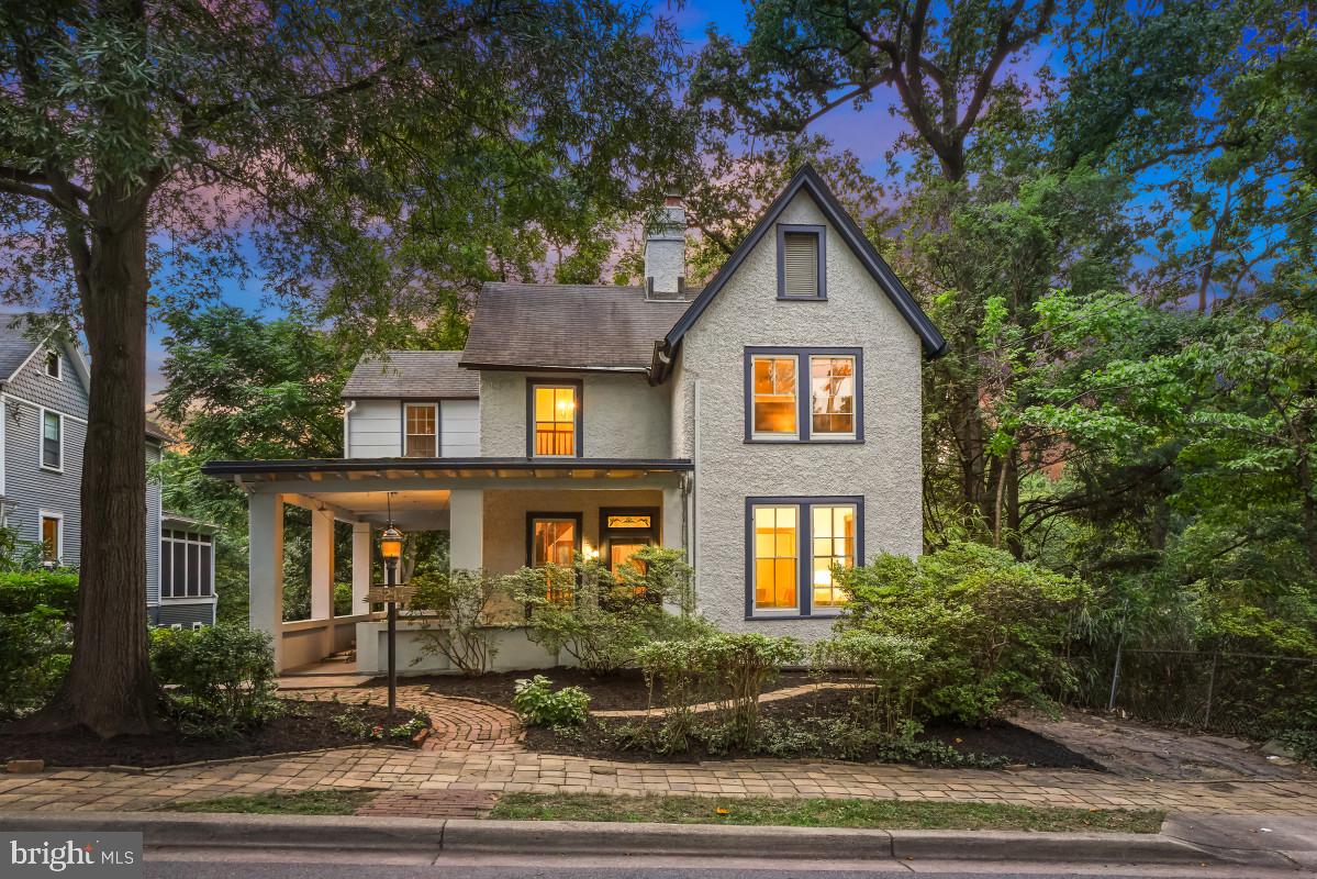 Welcome to 7214 Cedar Avenue! Built Circa 1873, this remarkable residence - a historic resource - predates the founding of Takoma Park itself, offering a rare opportunity to own one of the community's earliest homes. Located within the Takoma Park Historic District, it is rich in history and character and reflects the enduring appeal of one of the Washington area's most cherished historic neighborhoods.

This striking Farmhouse Colonial welcomes you with an inviting wraparound porch. Fine architectural details are showcased throughout, including detailed wood trim, original hardwood floors, transoms, a stained-glass window, multiple fireplaces, exposed brick walls, and period-inspired accents. The covered wraparound porch, original wood entry door with a generous glass pane and letter slot, beautiful stained-glass transom, and handsome staircase with its striking balustrade create a memorable first impression.

The home features a spacious living room with a brick fireplace that flows into the formal dining room. The traditional kitchen offers a fireplace, gas cooking, a tile backsplash, glass-front cabinetry, a ceiling fan, and access to the side entrance leading to the wraparound porch.

The upper level includes three bedrooms. The sun-filled primary bedroom features two closets and sconce lighting. The hardwood floors in both secondary bedrooms have been refinished. The upper level is complete with an updated ceramic tile bathroom and a linen closet.

The lower walkout level, with its private rear entrance, offers exceptional flexibility and includes a second full kitchen, a versatile family room or fourth bedroom with display shelving and brick accents, a full bathroom with a clawfoot tub, abundant natural light, and two large storage rooms. This level could easily serve as an in-law suite.

The outdoor setting is equally appealing, with mature, colorful landscaping, paver pathways, the wraparound porch, three patios, a driveway, and paver sidewalks lining this highly desirable block in the heart of Takoma Park. This premier location is minutes from the municipal library and community center, close to restaurants, shops, and the weekly farmers' market, and only blocks from K–8 schools, while being approximately 0.3 miles from the Takoma Metro. Ideally positioned between downtown Takoma Park and Silver Spring and near several local parks, this home offers vibrant in-town living with easy access to dining, shopping, and transportation.