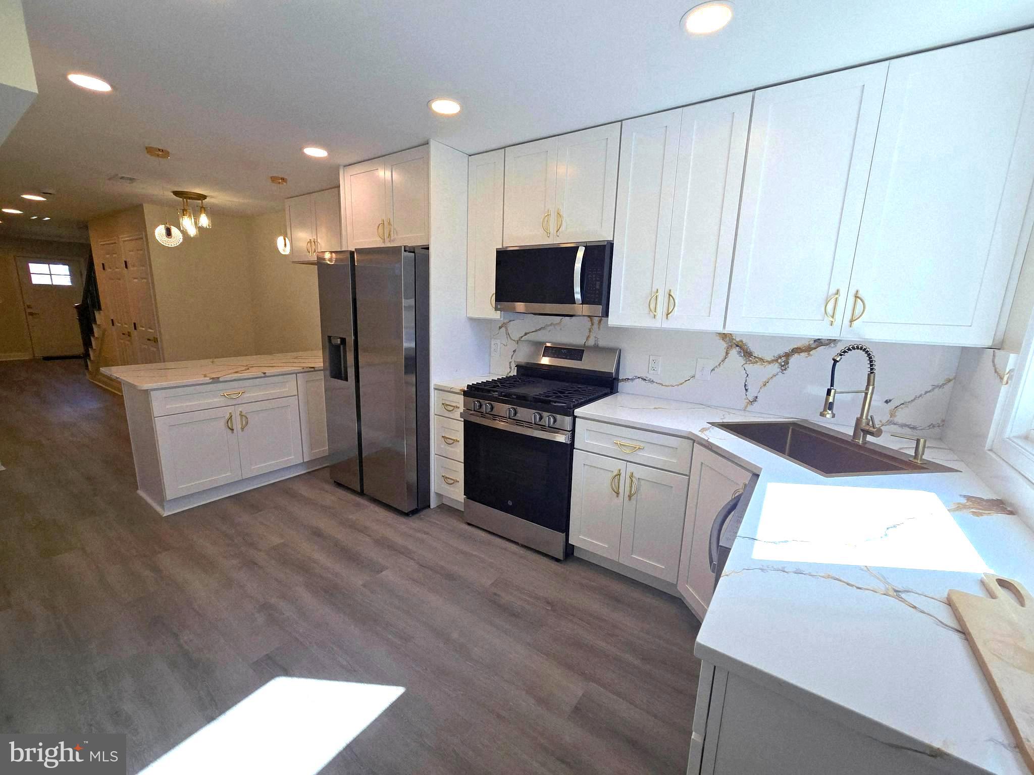 Located in the Mint Hill neighborhood of West Baltimore, this beautifully renovated rowhome offers far more than a typical renovation. Thoughtfully rebuilt with attention to detail throughout, the home feature elegant kitchen countertops, classy gold fixtures, stainless steel appliances, stylish ceramic tile bathrooms with additional Gold Details, and durable flooring throughout. The basement provides additional storage space. Conveniently situated just off Wilkins Ave, near Saint Agnes Hospital with easy access to I-95 and I-695.  This property combines modern design with everyday practicality!  Schedule your appointment today.