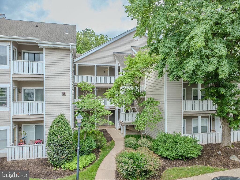 Elevate your lifestyle in this gorgeous, garden style condo community tucked away amongst wooded trails and 3 large ponds in Centreville. Minutes from Rtes. 28, 29 and I-66, this incredible location offers the best of everything. 2nd floor, 2-bedroom, 2 bath condo completely renovated in 2021; Kitchen, primary & secondary bathrooms, all new flooring, light fixtures and door hardware. Freshly painted with All textured ceiling removed throughout the condo. New and custom kitchen cabinetry, gorgeous upgraded granite countertops,  pendant lights and all new kitchen appliances. LVP flooring throughout the main living spaces and new carpeting in both bedrooms. Primary bathroom custom updated to include double vanity and additional cabinetry/storage. Walk in shower with custom tilework and wall niches. Granite countertops, new light fixtures, mirrors and faucets.  Both primary and 2nd bedroom walk-in closets feature rich, custom shelving and drawers to maximize and elevate the space. Wood burning fireplace anchors the living and dining rooms and the enormous, covered balcony is a source of peace and quiet overlooking heavily wooded common area. The crowning jewel of this wonderful condo is this incredible outdoor space with plenty of room for table and chairs as well as balcony seating and  bicycle or outdoor equipment storage. Secure, storage closet also offers additional space for tools, bikes and boxes. Beautifully situated at the end of Climbing Rose Way, the building is quiet and private with 1 assigned parking spot (C61) and plenty of visitor parking closeby. 
The pool & clubhouse recently renovated by the community, new gym/exercise room, racquetball courts, tennis and basketball courts and scenic ponds with walking paths. Close to shops & restaurants with Starbucks, the Cinemark Multiplex, Sweetwater Tavern & other fine dining and eateries less than a mile from your front door. Easy Metrobus access, and Dulles Airport is 9 miles/15 mins. Centreville Square and Centre Ridge Marketplace just a stone’s throw from the community with all conveniences and services. Don’t miss this renovated gem in Sanderling! New windows, doors and balcony resurfacing/painting slated for 2026-2027.