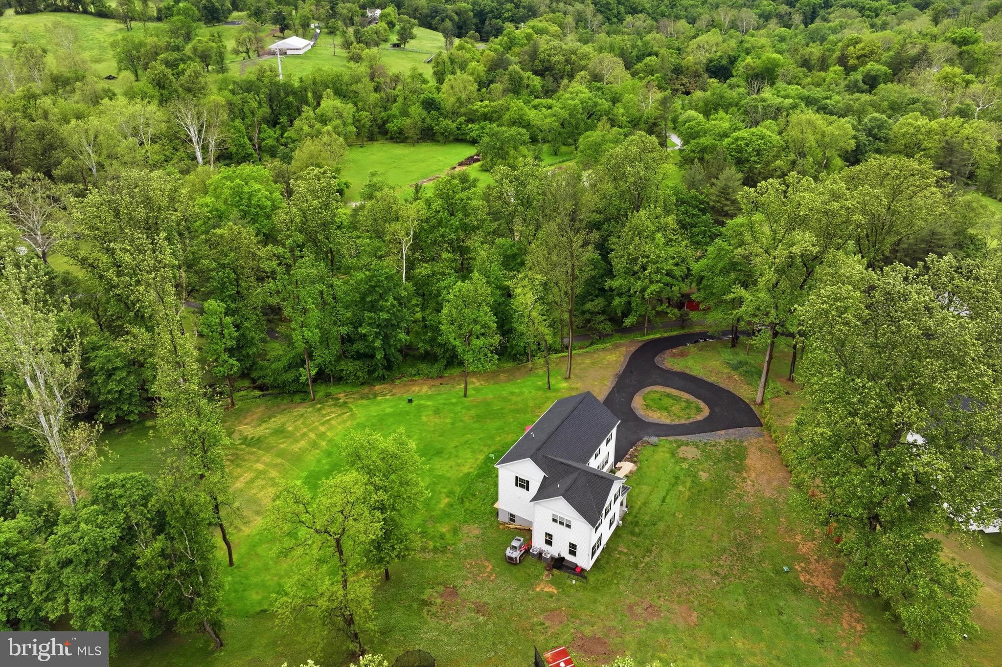 Located on 3.3 private wooded acres in the award-winning Garnet Valley School District, this exceptional 2025-built luxury estate offers a rare combination of privacy, acreage, and convenience. Featuring 4 bedrooms, 4 full baths, and approximately 4,279 SF of beautifully designed living space, the home is filled with natural light and upscale finishes throughout. The main level includes a gourmet chef’s kitchen with premium appliances, formal living room/library, full bath, dining area, and spacious family room with gas fireplace overlooking the serene wooded setting and mature trees. Upstairs, the luxurious primary suite offers a spa-style bath and generous walk-in closets, while a junior suite includes its own private bath. The finished walkout basement provides flexible bonus space ideal for a gym, media room, or recreation area. Additional features include a new paved driveway, 2-car garage, horse-friendly zoning, and no HOA. Enjoy the feel of a private estate property while remaining just minutes from Wegmans, Target, The Home Depot, dining, shopping, and major commuter routes.