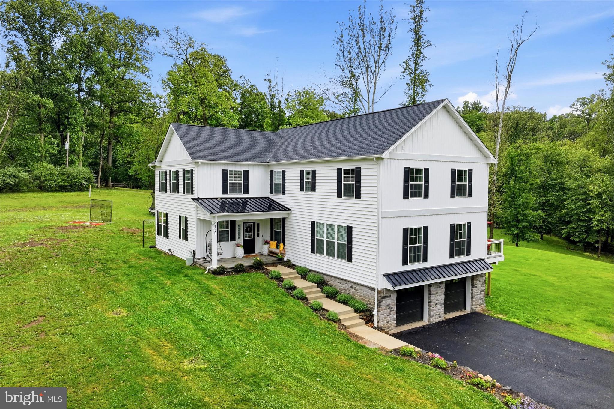 A rare 2025 rebuilt private estate in the heart of the Garnet Valley School District, offering 4 bedrooms, 4 full baths, and 4,279 finished square feet across three levels on 3.31 private, wooded acres. Taken down to the foundation and rebuilt with an expanded footprint, this home delivers the feel, function, and peace of mind of new construction in a setting that simply cannot be replicated.

The main level is designed for modern living, anchored by an impressive open kitchen and dining great room with an oversized island, walk-in pantry, and large windows framing the wooded views. A separate living room with fireplace adds warmth and definition, while a main-level full bath provides added flexibility for guests or everyday use.

Upstairs, all four bedrooms offer privacy and natural light, including a generous primary suite with a spa-style bath and walk-in closet. Three full baths and a dedicated laundry room complete the upper level, creating a true four-bedroom layout with room for family, guests, and real everyday function.

The finished walkout lower level adds valuable living space with a spacious family room and flexible bonus area, ideal for a home office, gym, media room, playroom, or guest space, with direct access to the rear yard.

Outside, the property separates itself from typical luxury inventory: a flat, regraded rear yard, expansive deck, circular driveway with ample parking, 2-car garage, horse-friendly zoning, and no HOA. Well/septic and metered propane serve the property. Minutes to the Wawa Train Station, Media, West Chester, Wilmington, and major highways, yet surrounded by a wooded setting that feels a world away. Very few homes offer this combination of 2025 construction, modern design, usable land, privacy, and convenience in Garnet Valley.
