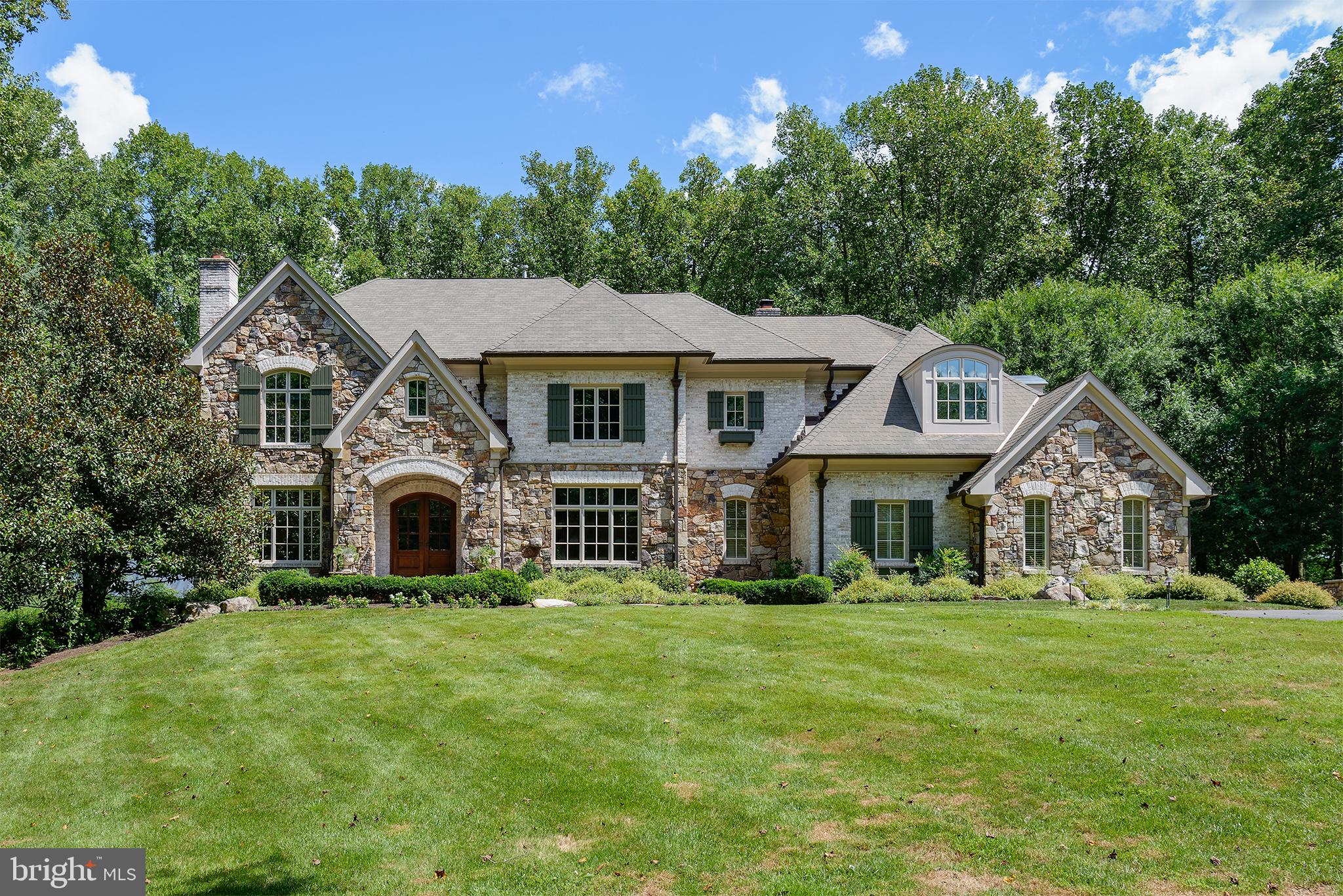 REDUCED!  Gorgeous custom home on 5.5 acres of tranquility! Virtual utube video:    Custom  Fieldstone and hand made Brick, Architectural Roof, Copper Gutters,  exterior  leads to Mature trees surround premises plus around the private swimming pool and hot tub, which leads you to your cabana with curved copper hip roof plus  hot tub and fieldstone fireplace, all for perfect entertaining!   Entertainers delight with outdoor built in kitchen , bath and dressing room and hot tub  for total relaxation.  Walk in to the Grand foyer with a nearby  Grand Curved Staircase.  Formal living room with fireplace and  Library  will greet your guests.  The open floor plan  includes  large gourmet kitchen with island  and stainless appliances ( 2 ovens, 2 dishwashers, wine refrig) , formal dining room,  large family room with fireplace and nicely appointed  built ins.  Family room leads to the Solarium/ Music Room and large deck overlooking swimming pool,  trees and perfectly landscaped yard. Dual Staircases lead Upstairs to Master Suite and two sets of Jack and Jills /Bonus Rm.   Lower level has additional bedroom and full bath with additional family room and bonus rooms for entertaining, then, walk out to the pool and cabana.  In addition to the 3 built in garage spaces, enjoy additional parking for cars, work space, cycles in the detached Carriage House!  Close to Tysons, and Great Falls Village!  Great Value!