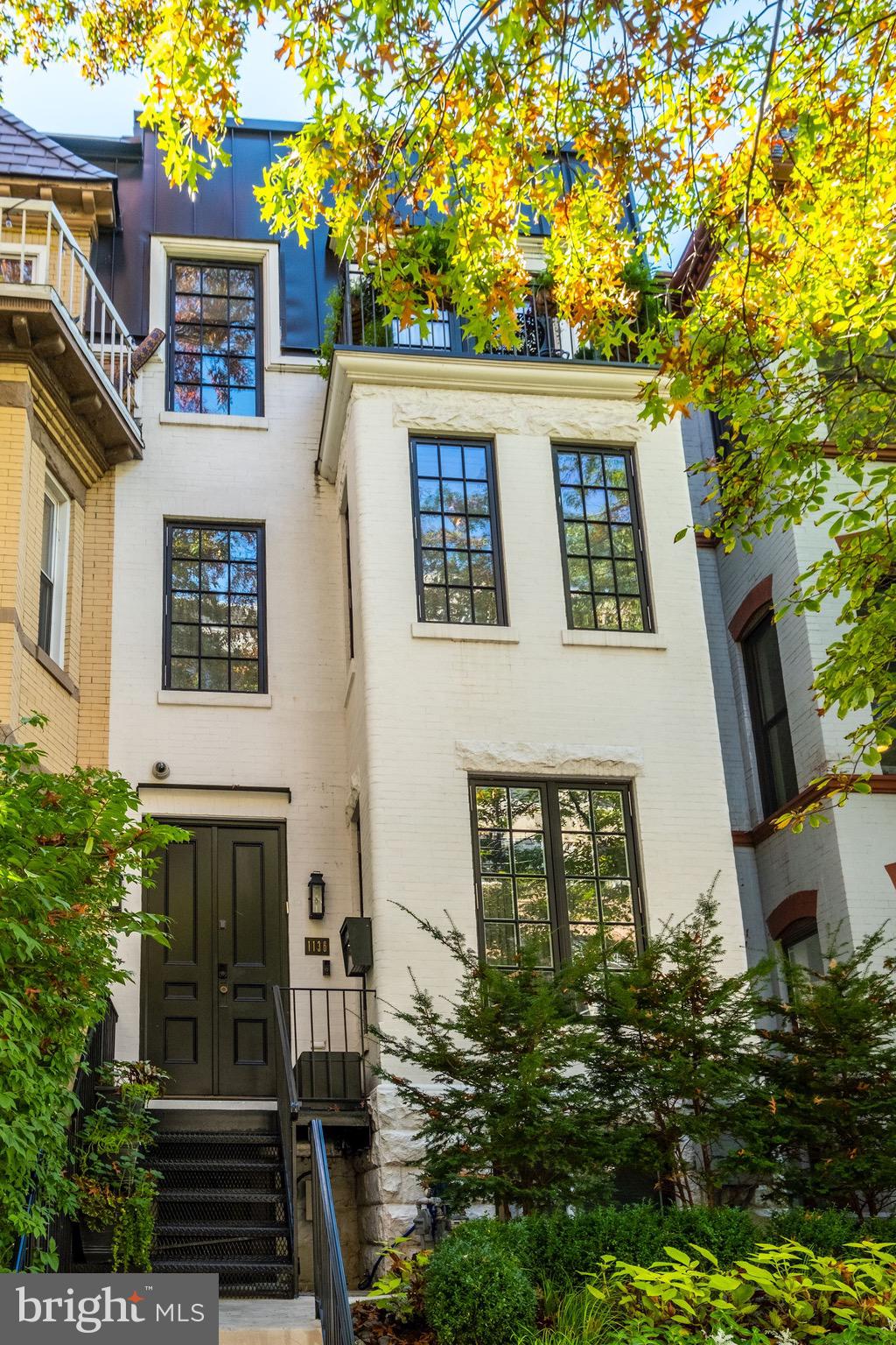 This stunning Victorian rowhouse is situated on a lovely residential street and enjoys a location that puts all that Washington has to offer right at its front doors. The impeccably maintained home, which spans over 3,500 square feet, has undergone extensive renovations and features modern amenities, smart home technology, and custom finishes throughout. The entry level features a dramatic living room with a fireplace, large dining room, gorgeous half bath and beautifully appointed kitchen with custom cabinets and high- end appliances. A wall of French doors in the kitchen allow light to flood in and provides access to an expansive rear patio with room for outdoor living and multiple car parking. The first upper level is dedicated to the owners suite which boasts an extensive collection of custom closets with thoughtful details, a large and light filled bedroom with a fireplace, office nook and an expansive designer bathroom complete with Waterworks fixtures, a steam shower, heated floors and a freestanding bathtub. The second upper level is home to an elegant office with custom shelving and pocket doors, two well appointed bedrooms, two tastefully renovated bathrooms and a balcony with lush plantings. A rooftop retreat unlike any other can be found just above the top level. Featuring a dining area, generous entertaining space with a fireplace and a comfortable lounge area with remote controlled louvers, this truly exceptional space can be enjoyed all year long. The lower level has a separate entrance that allows access to a large bedroom, high end bathroom, custom gym with steam shower, family room and laundry room. Abundant storage options are found throughout this level as well as a Subzero wine fridge with space for 130 bottles. With four finished floors featuring the highest level of craftsmanship and detail, secure parking for up to four cars and an elevator serving each floor including the roof top oasis, this home represents the finest in modern living.