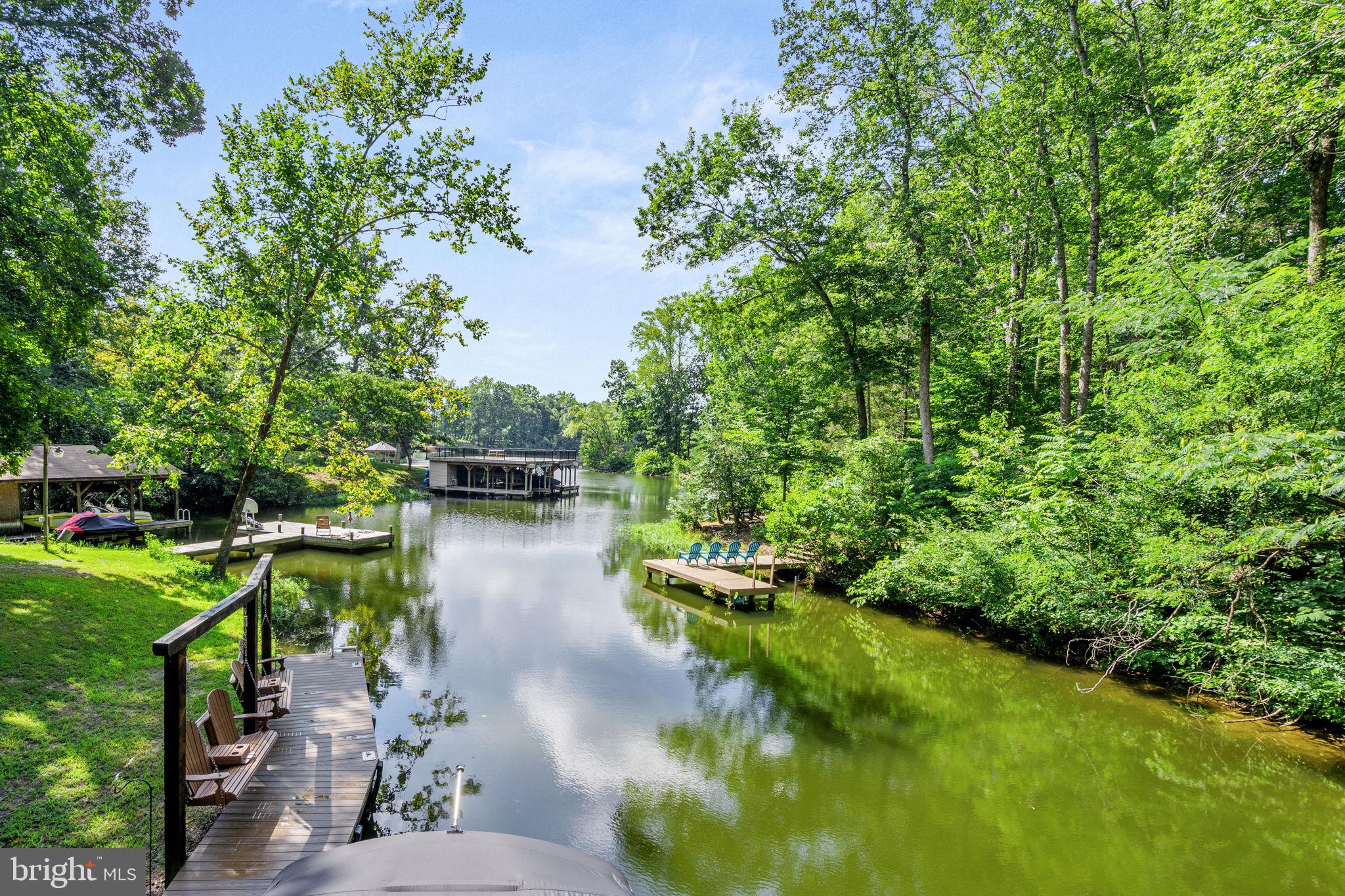 ** OPEN HOUSE - SUNDAY, 7/19 @ 1-4 PM ** WATERFRONT GET-AWAY ** EXCLUSIVE OPPORTUNITY on 4-ACRES ** USE 3816 BEAR TREE LANE, BUMPASS FOR DIRECTIONS ** Don't miss this RARE find with TWO ADJOINING LOTS FOR SALE! Two for the price of one with 3937 Breaknock Rd + 3816 Bear Tree Lane and a total of 4 acres with a custom, newly updated two-level dock. Located on the public side of Lake Anna in a prime location, in a quiet private cove just down from Duke's Creek Marina. This gem is tucked away to enjoy your private dock (with an electric boat lift), huge sundeck for catching the rays, enjoying the view, or entertaining family & friends. The cozy 3 BDRM, 2 BATH home boasts over 1,200 finished square feet. Renovated with a new kitchen, updated bathrooms, new flooring, new windows, siding & roof - practically a brand new house! The Kitchen has granite counters, stainless steel appliances, and updated cabinetry. Both primary & hallway bathrooms are completely renovated with custom tile work & updated fixtures. The exterior features a wrap-around deck, extension hardscaping to include a firepit area, new pole barn, and....saving the best for last....an UPDATED DOCK (Spring 2025) with composite decking and a BRAND-NEW second-level sundeck. The adjoining lot is already cleared & ready for another home, or just keep it clear and private to use for family games, gatherings, or even the perfect camping pad! Updates to include: Exterior doors (2026), Dock (2025), Pole Barn (2023), Primary Bath (2020), Deck & Patio (2019), Kitchen & Hallway Bath (2017), Mechanicals (2017), Roof (2016). This convenient location is just down the road from Elk Creek Country Store, Lake Anna Taphouse, Vito’s Pizza, Asian Café, and New Bridge Landing (groceries, ABC, nails, and more). Lake Anna is centrally located—only 45 minutes to Richmond, Charlottesville, and Fredericksburg, and about 90 minutes to D.C. Don’t miss this rare opportunity to purchase two lots for the price of one on Lake Anna. Schedule your private showing today and experience lakeside living at its finest!