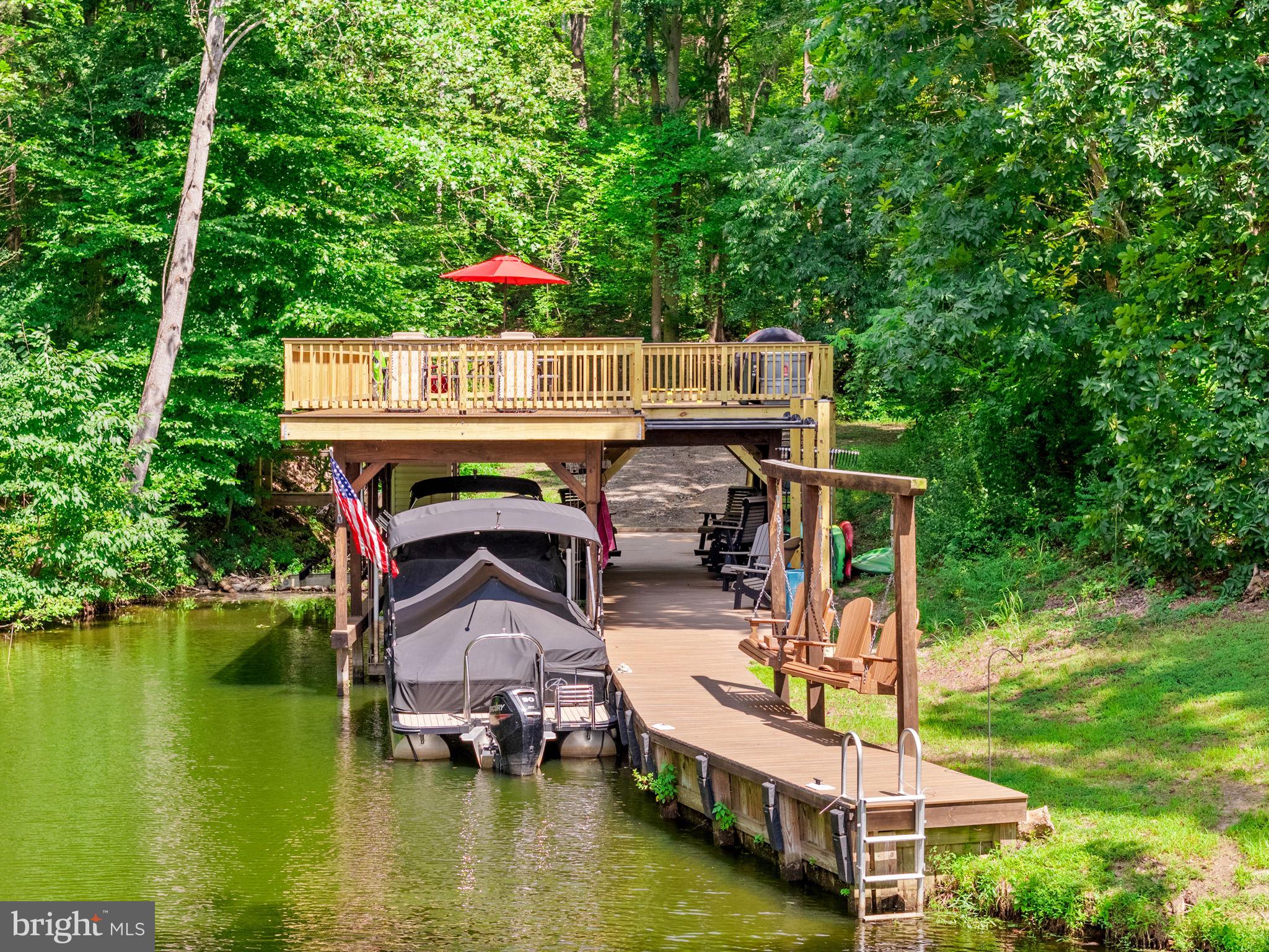 ** PRICE IMPROVEMENT ** EXCLUSIVE OPPORTUNITY on 4-ACRES, WATERFRONT ** USE 3816 BEAR TREE LANE, BUMPASS FOR DIRECTIONS ** Don't miss this RARE find with TWO ADJOINING LOTS FOR SALE! Two for the price of one with 3937 Breaknock Rd + 3816 Bear Tree Lane and a total of 4 acres with a custom, newly updated two-level dock. Located on the public side of Lake Anna in a prime location, in a quiet private cove just down from Duke's Creek Marina. This gem is tucked away to enjoy your private dock (with an electric boat lift), huge sundeck for catching the rays, enjoying the view, or entertaining family & friends. The cozy 3 BDRM, 2 BATH home boasts over 1,200 finished square feet. Renovated with a new kitchen, updated bathrooms, new flooring, new windows, siding & roof - practically a brand new house! The Kitchen has granite counters, stainless steel appliances, and updated cabinetry. Both primary & hallway bathrooms are completely renovated with custom tile work & updated fixtures. The exterior features a wrap-around deck, extension hardscaping to include a firepit area, new pole barn, and....saving the best for last....an UPDATED DOCK (Spring 2025) with composite decking and a BRAND-NEW second-level sundeck. The adjoining lot is already cleared & ready for another home, or just keep it clear and private to use for family games, gatherings, or even the perfect camping pad! Updates to include: Exterior doors (2026), Dock (2025), Pole Barn (2023), Primary Bath (2020), Deck & Patio (2019), Kitchen & Hallway Bath (2017), Mechanicals (2017), Roof (2016). This convenient location is just down the road from Elk Creek Country Store, Lake Anna Taphouse, Vito’s Pizza, Asian Café, and New Bridge Landing (groceries, ABC, nails, and more). Lake Anna is centrally located—only 45 minutes to Richmond, Charlottesville, and Fredericksburg, and about 90 minutes to D.C. Don’t miss this rare opportunity to purchase two lots for the price of one on Lake Anna. Schedule your private showing today and experience lakeside living at its finest!