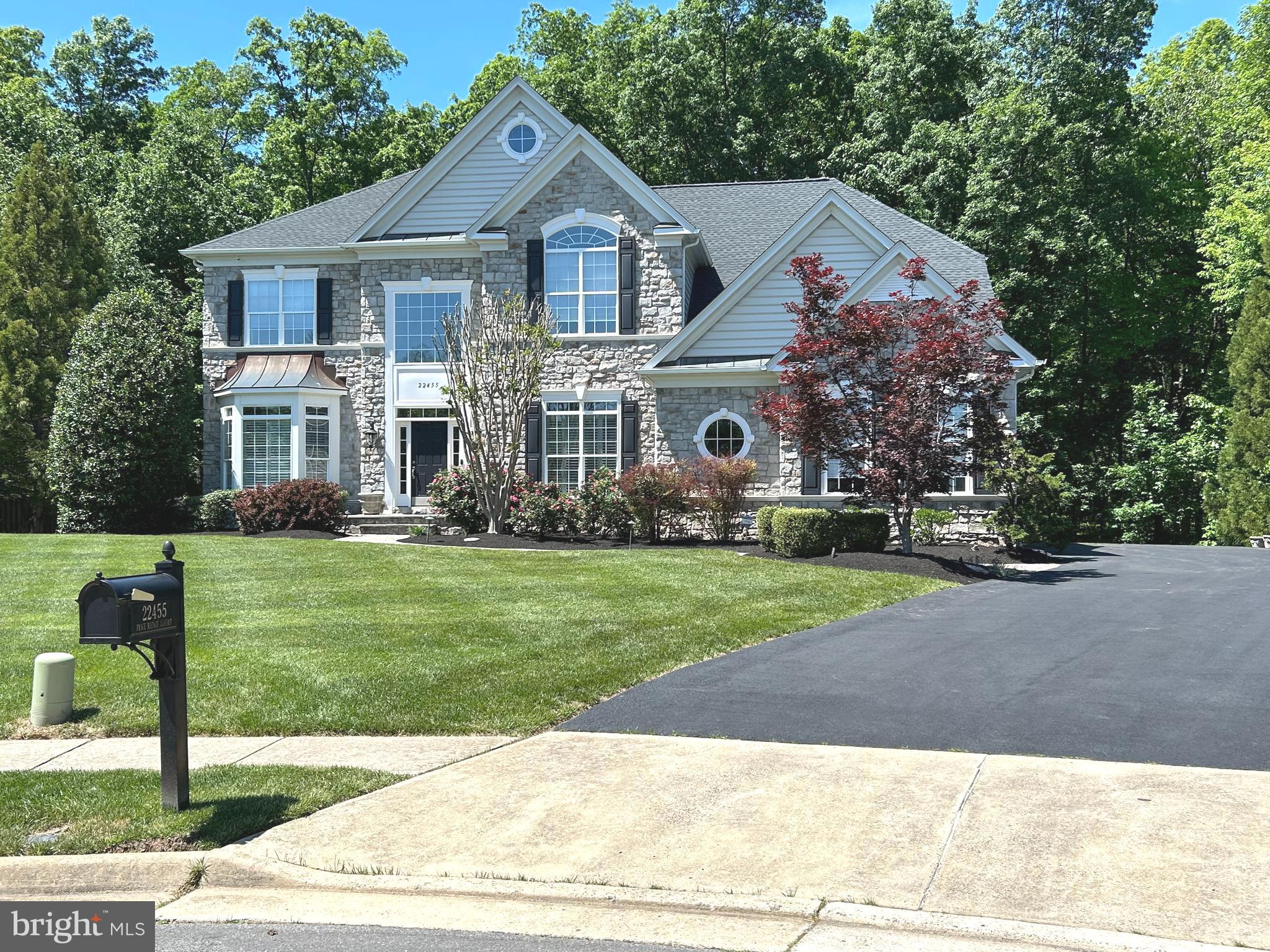 NEWLY UPDATED & MOVE-IN READY! This stunning executive home has just been beautifully refreshed with stylish contemporary flooring, new carpet and an upgraded kitchen & butler’s pantry featuring crisp white cabinetry and quartz countertops—truly showing better than ever!

Tucked away on a quiet cul-de-sac in one of Ashburn’s most sought-after neighborhoods, this exceptional 5-bedroom, 5.5-bath, 3-car garage home offers over 6,000 sq. ft. of elegant living space across three finished levels, set on a private half-acre wooded lot with usable yard space.

The main level is filled with wonderful architectural details including wainscoting, wall cutouts, niches and a dramatic staircase framed by a grand two-story foyer. The beautifully updated kitchen is ideal for both everyday living and entertaining and is complemented by a butler’s pantry with bar sink and beverage refrigerator. A spacious formal dining room provides the perfect setting for gatherings, and the home office features custom built-ins with a granite desktop and tranquil views of the yard. The inviting family room offers a cozy retreat centered around the brick fireplace.

Upstairs, you’ll find five generously sized bedrooms on one level, all with walk-in closets. Three bedrooms feature ensuite baths, while the remaining two share a buddy bath—perfect for larger households or guests. The primary suite is a true sanctuary, highlighted by a beautifully renovated luxury bath, complete with a standalone soaking tub and heated towel rack for ultimate relaxation.

The lower level delivers incredible entertainment space with the charm of a classic London pub, featuring a custom bar and pool table which conveys. Enjoy movie nights in the private home theater, plus a full bath, fitness room, and an additional unfinished bonus room currently used as a workshop.

Step outside to a park-like backyard oasis, ideal for entertaining or relaxing. Enjoy the screened porch with ceiling fans and Bose speaker system, or host summer cookouts on the flagstone patio with a built-in gas grill. As the sun sets, landscape lighting and a flagstone fire pit create a warm and inviting atmosphere. 

Conveniently located near the Ashburn Metro and the Brambleton Town Center, with restaurants, shops, library, movie theater, events, and even weekly farmer’s markets! 

This home truly offers the ultimate in memory making opportunities! Schedule your private tour. New Roof & HVAC (2022).