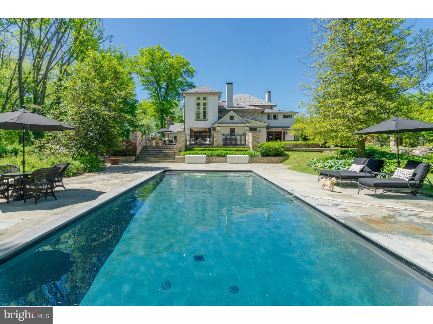 Welcome to Stonewell, the personification of fine Bucks County living in its highest form. Located on one of the area's most desirable country roads, this c. 1851 stone home proudly reveals itself amid a clearing of lush plantings and rolling lawns. Stone walls and iron gates frame the house in this verdant oasis and usher you inside via a European-inspired front courtyard. Grandeur, elegance, warmth and comfort seamlessly harmonize throughout stately yet casual main level rooms where high-style period details are abundant, beginning in the handsome entry room. Tall, deep set windows and distinctive plaster molding perfectly accessorize the chicly appointed living room with wood burning fireplace and the tasteful study. An impressive stone hearth anchors the light and open kitchen with granite counters, a large island with bar seating and stainless-steel appliances. Folding glass walls surround oversized dining and entertaining areas, seamlessly integrating a luxe yet casual ethos both inside and out. Vaulted ceilings with exposed beams, another fireplace and natural design elements like exposed brick and stone set the tone in the inviting family room. Each of the grand yet unpretentious rooms in this wing enjoys access to the stunning grounds just beyond. A terraced slate patio accented with custom ironwork presents various outdoor living, dinning and relaxation options, all culminating at the property's jaw dropping, resort-style pool. Mature trees enrich the bucolic setting as they shroud manicured lawns and gardens in total privacy. Back inside, convenient mud, laundry and powder rooms complete the first floor. A recent extension to the second level houses an impeccable master retreat where light bursts through walls of windows with charming Juliette balconies in the sleeping and sitting rooms, while a dream walk-in-closet/dressing room contains custom built-in storage behind mirrored doors, and a fresh & modern, spa-like bathroom round out the suite. Two well-proportioned bedrooms and another full bath are also located on this level, while another large bedroom sits atop the third floor with its own full bath. With simply too many features to list, this rare jewel must be seen to be fully appreciated! See the virtual tour of the property on line.