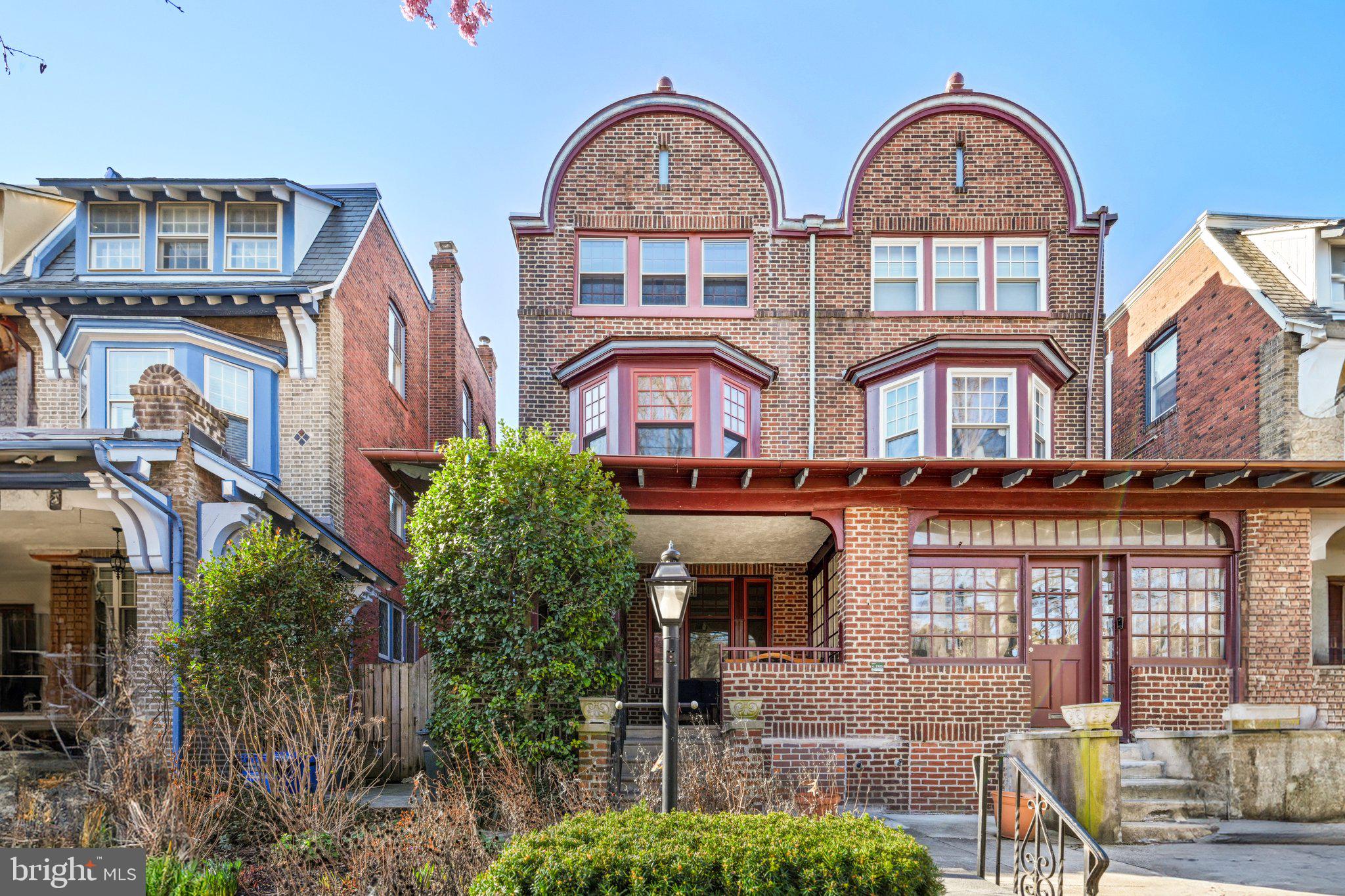 West Philly’s best! This historic 2718 sf, 3-story home c.1921 in the 100+ year old Garden Court neighborhood of University City still has all of its handsome original details – leaded glass, hardwood flooring with decorative borders, beamed ceilings, original woodwork and staircases – and in an unusual window above the brick living room fireplace, a stained glass depiction of a vine or tree which appears to be growing large purple grapes! Up-to-date amenities have been added in recent years, including a cook’s kitchen, newer baths, a/c, plenty of subtle lighting, and modern wiring. The 4600 block of Larchwood Ave. is one of the very best blocks in the neighborhood, and in the catchment area for the high- rated K-8 Penn Alexander public school.* The front garden begins to come to life in March, and the front porch has space for sitting and admiring the block, maybe waving to the owner-occupant neighbors walking by. A vestibule leads to the living room with its wood- burning fireplace. The full dining room is bright and airy, with a 3- window bay. The sleek, efficient kitchen has eat-in space at the island and a pantry for additional storage. Out back is a covered porch with steps leading down to a brick patio and garden beds. Upstairs, there are 3 bedrooms (originally designed as 2 plus a family room), a “sleeping porch” and a luxurious bath on the second floor; and on the third floor, 2 more bedrooms, an exercise room/family room and another bath. The semi-finished basement with a half bath is a great space for storage and a workshop, game room or play room, and laundry. The location is just 2 blocks north of Baltimore Avenue, West Philly’s "main street," known for its eclectic restaurants, bars & shops. Two parks - Cedar Park and Clark Park - are close by. If you want to venture farther, hop on the trolley - the ride to center city takes only 15 minutes, stopping at UPenn, Drexel U and the 30th St. transportation hub along the way. (*Catchment address doesn't guarantee admittance.)