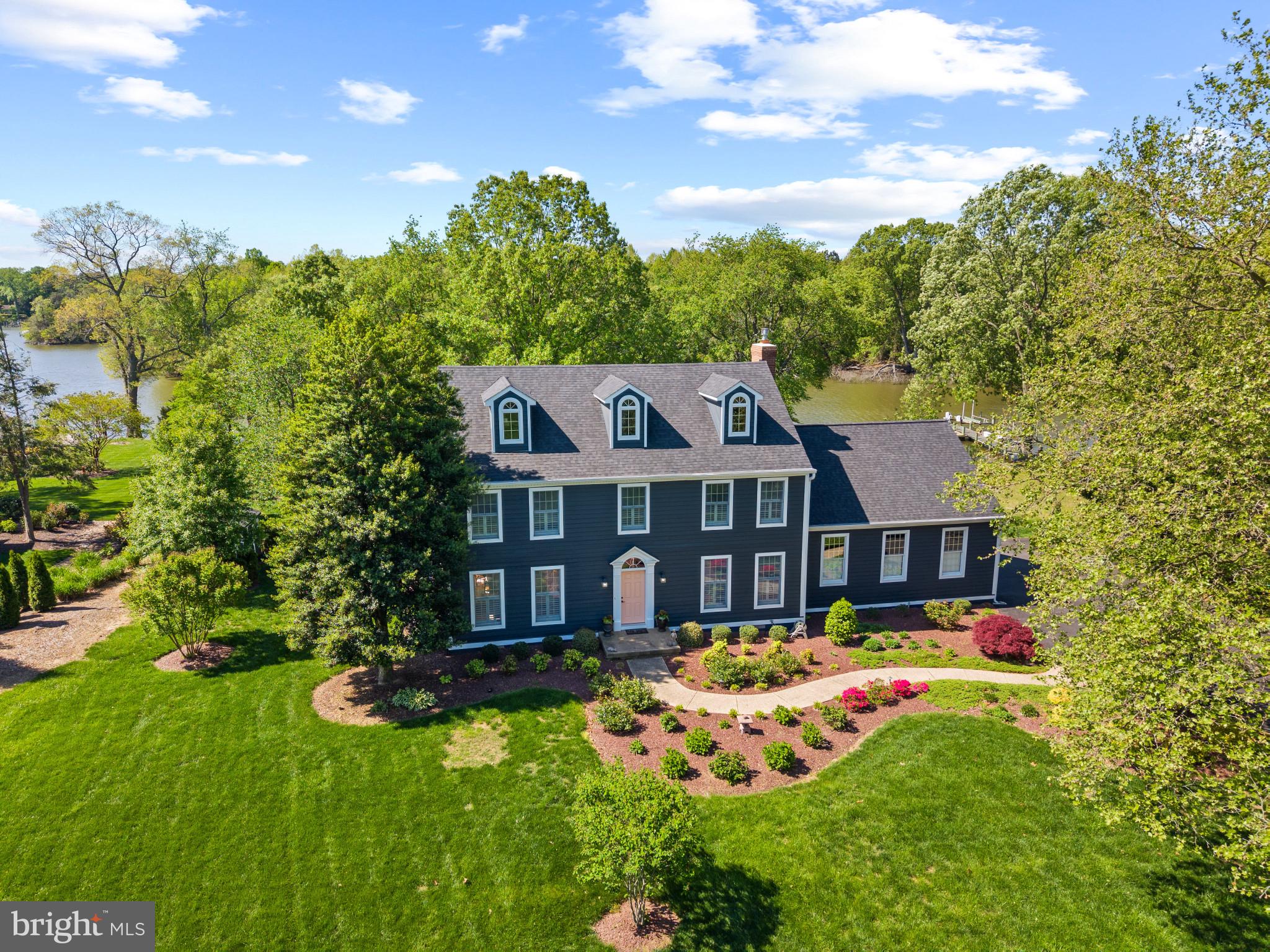 Welcome home to this beautiful waterfront home situated on just over an acre  and a half of land in the peaceful Wye Harbor community in Queenstown, minutes from Route 50. Enjoy Wye River water views throughout, multiple living spaces, a large sunroom facing the water, plenty of storage, and an unfinished attic space perfect for a recreation room or additional storage.  This home has something for everyone! 

As you enter, the foyer provides access to a beautiful stairway or either of the two formal living areas. Boasting the perfect blend of open concept and traditional layouts, the formal living room off the foyer seamlessly integrates into the formal dining room with direct access to the kitchen and open concept living and dining spaces overlooking the Wye River. The large living space features high ceilings and direct access to the sunroom, with some of the best views of the River! The two car garage can be accessed via the mud room connected to the living space as well. 

The primary suite features a spacious room with a farm house style bathroom and an oversized walk in closet that leads to another unfinished room - the potential is endless! This space could be the perfect dressing room, extra storage, or whatever you can imagine. The three additional bedrooms upstairs offer plenty of space for guests am additional storage. Inside one of the bedrooms, you’ll find a hidden stairway leading to the unfinished upper level, currently used as a recreation area and the perfect spot to add additional square footage to this already spacious home. 

Outside, you’ll find a beautifully manicured lawn, mature landscaping, and a pier with 3-4ft MLW as well as electric and water. The Wye River is one of the most premier spots for boating in Maryland, perfect for a cruise around Wye Island or taking a quick trip to Saint Michaels, the Narrows, and beyond. 

Wye Harbor is located minutes away from Route 50, the emergency room, doctors, and the Queenstown Premium Outlets. Just a short drive to Kent Island, Annapolis, Easton, Saint Michaels, Centreville, and beyond. The community doesn’t have an HOA, however they regularly schedule social events and get togethers. Schedule your tour today to learn more about what the Eastern Shore and this community have to offer!