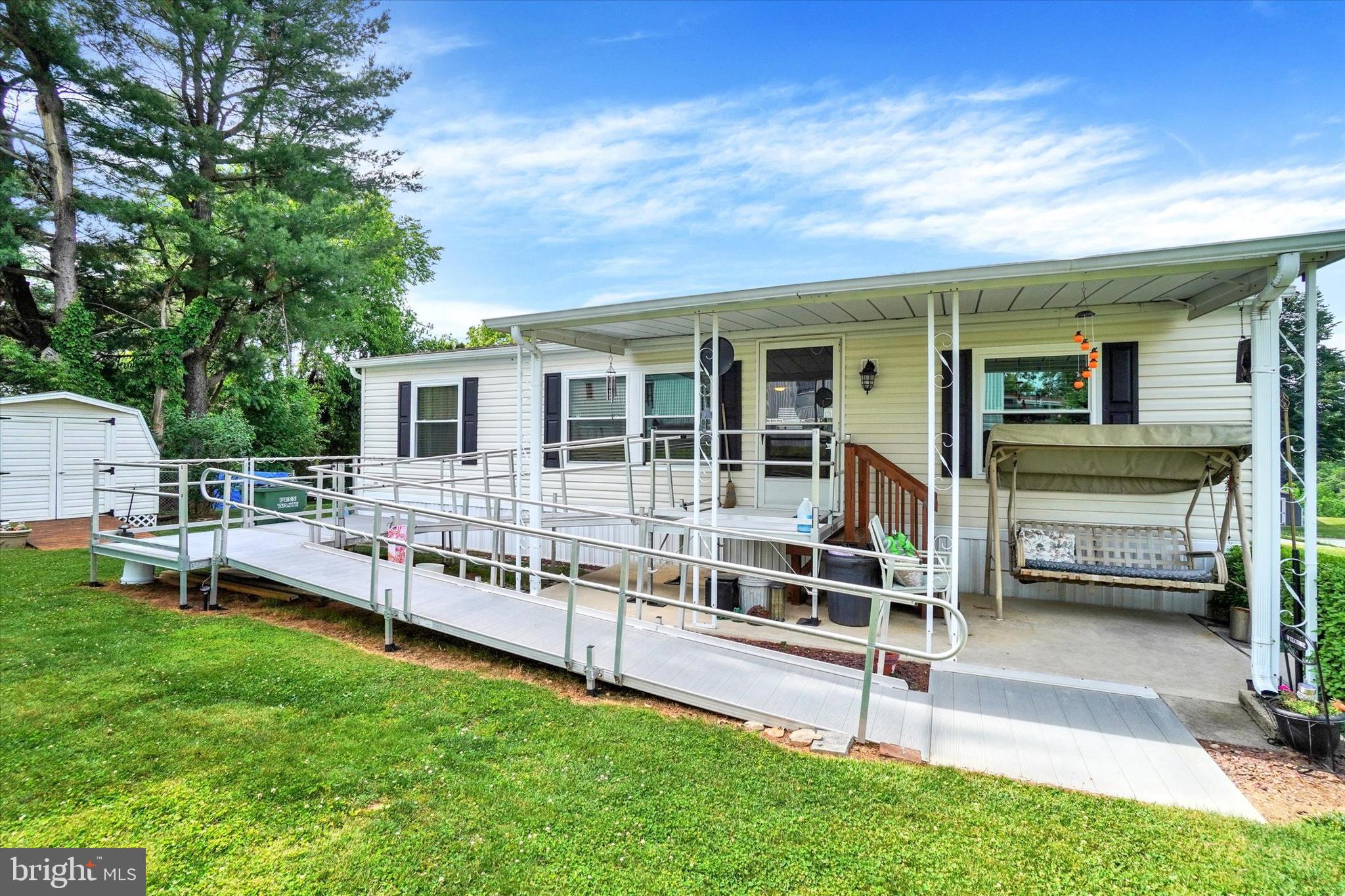 With a tree line to the rear, this 1 story living home sets in a 55+ neighborhood. In the living room, there is a pass thru window to the Eat-in-Kitchen, the Laundry area is here with a door to a small deck, the Owners Bedroom Suite has a step in shower and a walk in closet, the main bath offers a tub shower, additions include: a ramp, grab bars, new Hot Water Heater, Refrigerator and Dryer.