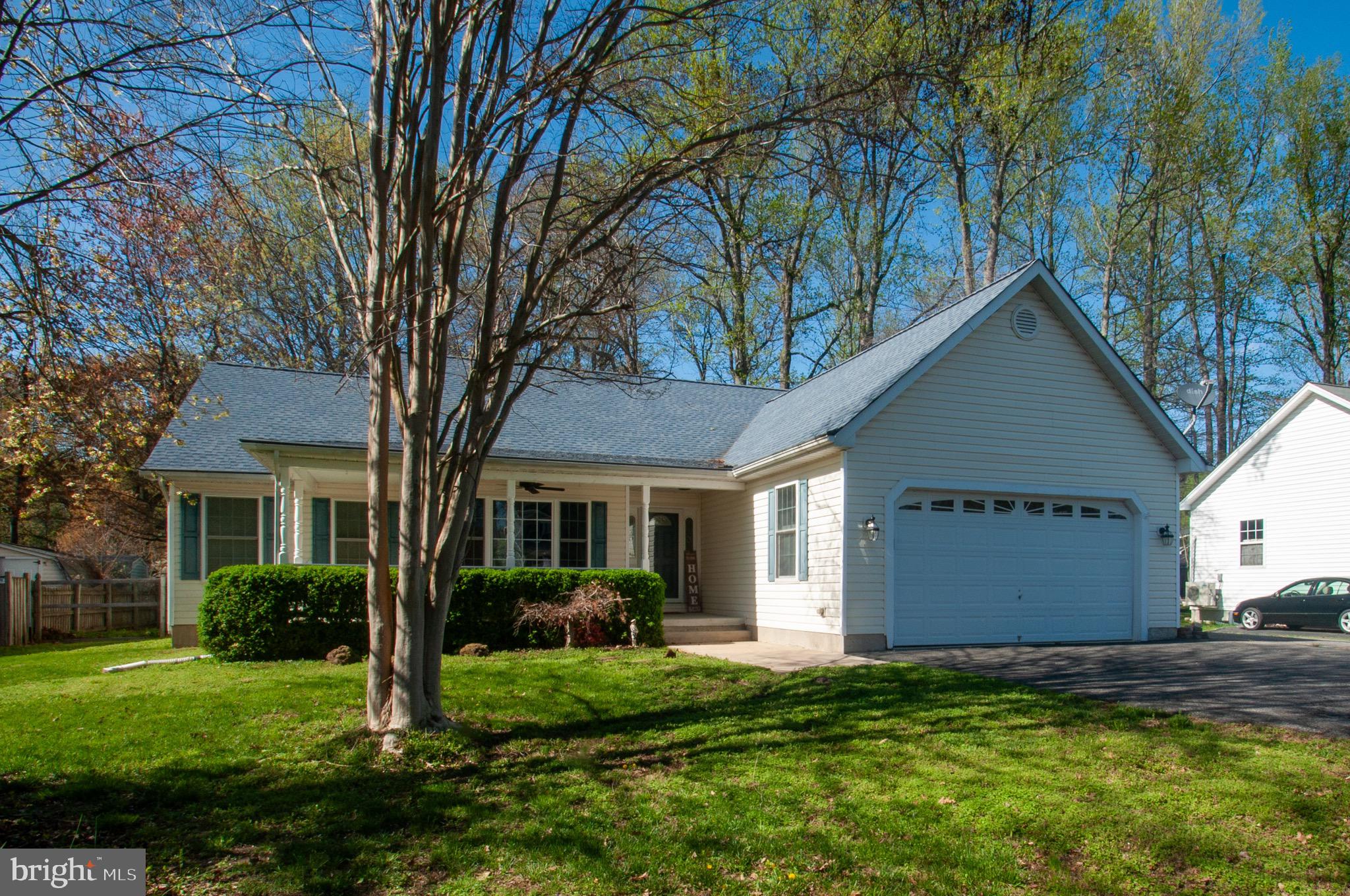 Terrific Rambler with cute wrap around porch, backing up to  Wicomico Shores Golf Course. This split bedroom design makes the living area the heart of this home.  Open kitchen concept with recessed lighting, Corian counter-tops, gas stove, pendant lights and large pantry. Kitchen overlooks great room, eat in area with beautiful bay window and Formal dining room/office or playroom. Recent LVP flooring  throughout main living areas. Great room with French doors opens to screened in porch that leads to deck and fenced yard. Owners suite has full bath, second full bath located between the addition two bedrooms. Laundry room leads to 2 car garage with very cool pull down screen door. Extra parking area ideal for RV,  and for more storage there is a shed and pull down attic storage. VA assumable 2.8% loan with substitution of VA entitlement and release of liability