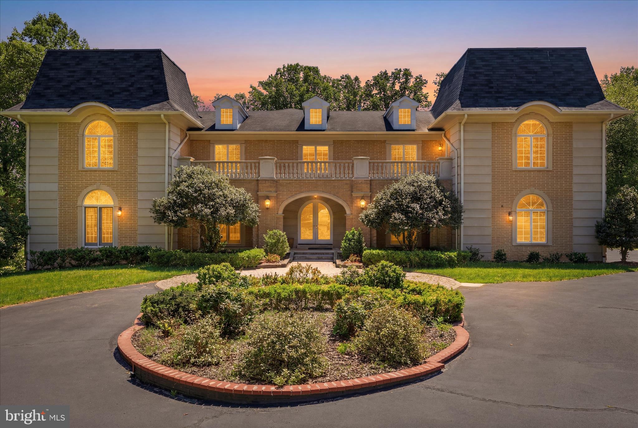 Own a true work of art-this stunning masterpiece will make you proud every single day! 

Magnificent French Chateau Estate on 2.1 Private Acres in Prestigious Great Falls. Truly one of  a kind!

Commanding attention with its striking blue-grey mansard roofs, twin turrets, and ornate sandstone balcony railings, this distinguished sandstone French Chateau-style residence is a true masterpiece of European craftsmanship. Set on a generous 2.1-acre lot, the home offers over 10,451 square feet of finished living space and delivers the perfect balance of timeless elegance, modern luxury, and effortless indoor-outdoor living in one of the area’s most sought-after communities.

Grand Interior Living
Step into a breathtaking two-story marble entrance hall featuring a sweeping double wooden staircase with solid cast iron gold painted railings and a sparkling crystal chandelier. Fluted pillars crowned with molded wreaths frame the formal living and dining rooms, both boasting rich marble and hardwood floors.

Signature spaces include:
• Elegant Study / Front Parlor with custom built-in bookcases surrounding a fireplace with gilded detailing, opening to a private patio.
• Dramatic Two-Story Family Room with soaring ceilings, a show-stopping fireplace framed by gilded goddesses, full-height windows, and seamless access to the lush, wooded grounds through walls of glass.
• Dual Entertaining Bars with marble  counters, wine coolers, refrigerators, and dishwashers — ideal for  hosting guests.
• Gourmet Kitchen featuring marble counters, a furniture-grade stove, GE Profile appliances, decorative  backsplash tile , and an adjacent sun-filled morning room overlooking the private lot.
• Private Premium  Elevator for effortless movement between all levels.
• Additional highlights: family theater, sauna, wine cellar, powder room, abundant walk-in closets, and a hardwood gallery overlooking the foyer and family room.

Premium Features & Amenities
• Five built-in mantel fireplaces throughout the home
• Advanced security system
• Hot tub / whirlpool
• Soaring 2-story 20 feet , cathedral, and tray ceilings
• Extensive hardwood and marble flooring
• Crown moldings and recessed lighting
• Open floor plan designed for both grand entertaining and comfortable daily living

Main Level
The dramatic center-hall foyer with marble flooring flows seamlessly into sophisticated living spaces, including a gourmet kitchen with island, eat-in area, butler’s pantry, double wall ovens, and gas fireplace; a breakfast room with its own gas fireplace; formal living and dining rooms; a private library with fireplace; and a main-level bedroom and den.

Upper-Level Retreat
The luxurious primary suite is a true sanctuary, featuring a spacious bedroom, sitting room with gas fireplace, and opulent primary bath. Three additional bedrooms with its own living room, a large study, and a loft provide exceptional space for family, guests, or a home office.

Fully Finished Walkout Lower Level
More than 2,900 square feet of additional living space with abundant natural light and multiple walkout entrances. Highlights include an entertainment-ready game room / family theater with gas fireplace, additional family room, exercise room, bedroom, and bonus room — perfect for recreation, guests, or multi-generational living.
This exceptional estate masterfully blends old-world European charm with every modern high-end amenity. Offering privacy, scale, and unmatched lifestyle, it is ready for its next discerning owner.

Schedule your private showing today to experience this one-of-a-kind Great Falls residence.