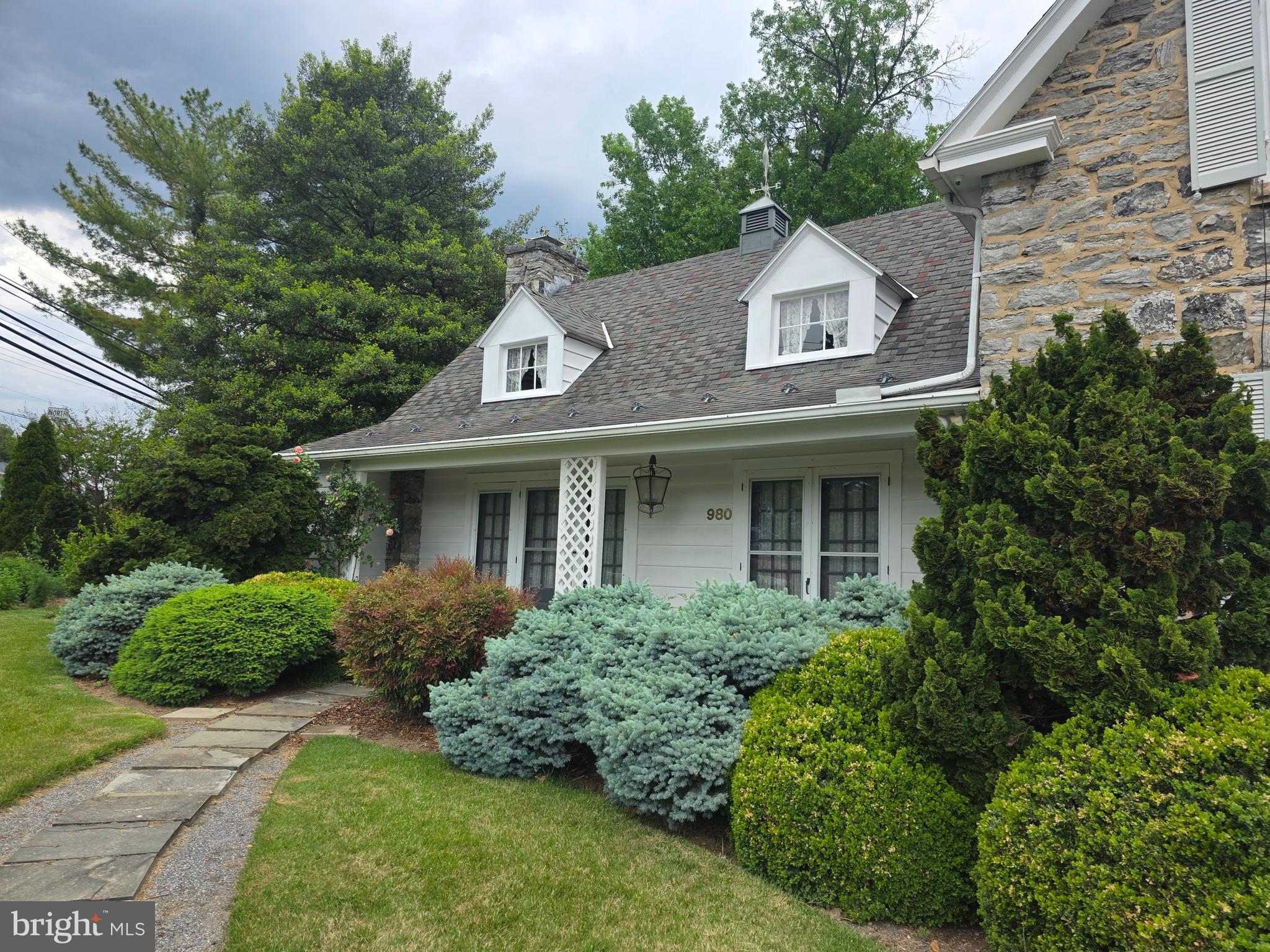 Welcome Home to 980 Northern Avenue! Yes, this is THE house! Well-known by locals, and sitting directly on the corner of northern and Pennsylvania, it's impossible to miss the uniqueness of this home when passing by.  An Iconic Hagerstown gem, this historic stone cape-cod has for years turned heads with it's European/new-England-style charm.... Mostly catching eyes due to the extensive and impeccable landscaping throughout the entire property. The home sits on 0.51 acres, the entirety being manicured to the finest for decades... this truly is a gardeners paradise! The property features 2 outbuildings: a detached/oversized garage w/loft, and a cottage-style storage shed, both perfectly & intentionally  matching the landscape. The home features 3 bedrooms and 2 bathrooms. There are hardwood floors throughout the entire property, and a full basement. There is a wood burning fireplace in the living room. NO CITY TAXES! County-Only! Don't wait, this one won't last long! Tours will start in June, call ahead to schedule yours!
