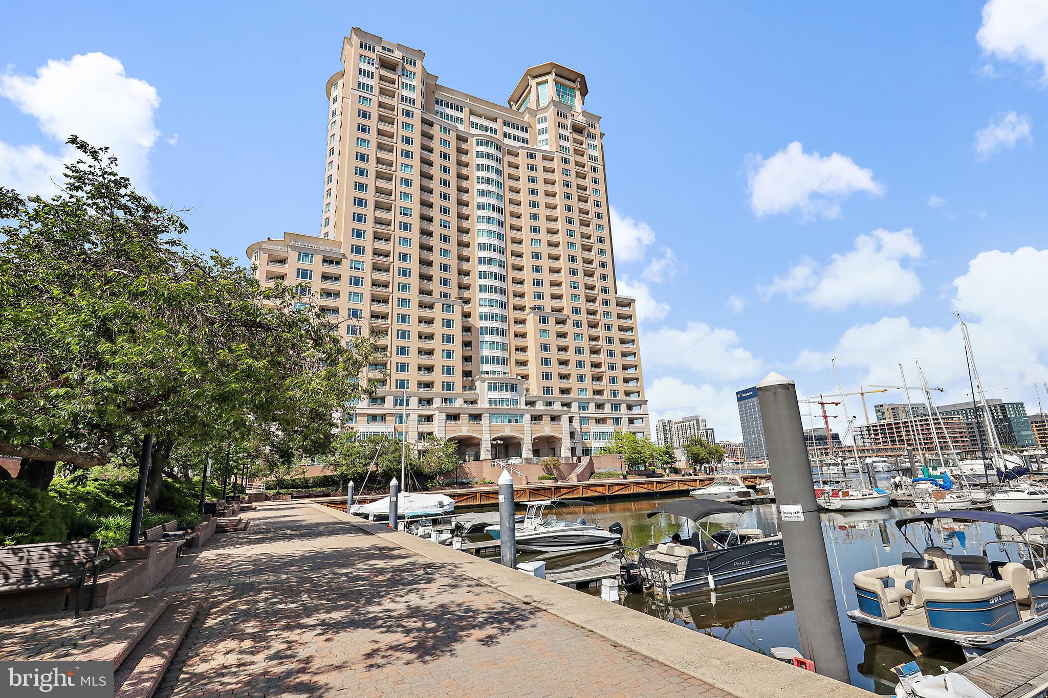 Exceptional Waterfront Luxury Condo with Unmatched Views and Exclusive Amenities!  Experience resort-style living at its finest in this spacious 1-bedroom plus den waterfront condo, offering views of the Harborview Marina and the iconic Domino Sugars. With its open design and exquisite details of custom wood accents, crown molding and specialty lighting, this home combines comfort, style, and convenience. The gourmet kitchen, upgraded features, and spacious main suite make it the perfect retreat. The main suite bath features dual bowl sinks, tub and a stall shower.  The den, with its private balcony, offers the perfect space for relaxation if used as a second bedroom, or working privately if used as an office. This exceptional condo boasts numerous upgrades, providing a comfortable living experience. Two assigned gated garage parking spaces! Additional spaces can be rented. Resort-Style Amenities Include:  24/7 front desk concierge service, Outdoor grill area, stylish social lounges with billiards, Business center, conference rooms, elegant banquet rooms, Bike storage and a state-of-the-art fitness center which includes both steam and sauna rooms, Indoor and outdoor pools, perfect for year-round relaxation.  Beautifully landscaped gardens, walking/jogging paths, picnic benches, and tranquil fountains throughout the community, Gated garage parking and on-site security staff for peace of mind.  Located just moments from the vibrant Inner Harbor,  downtown business district, gourmet restaurants, both stadiums, commuter rail, and only 9 miles to BWI Airport, this condo offers the perfect balance of serene living and ultimate convenience.  Live where luxury meets lifestyle. Don’t miss out on this rare opportunity—schedule your tour today and make this resort-style condo apartment your new home!