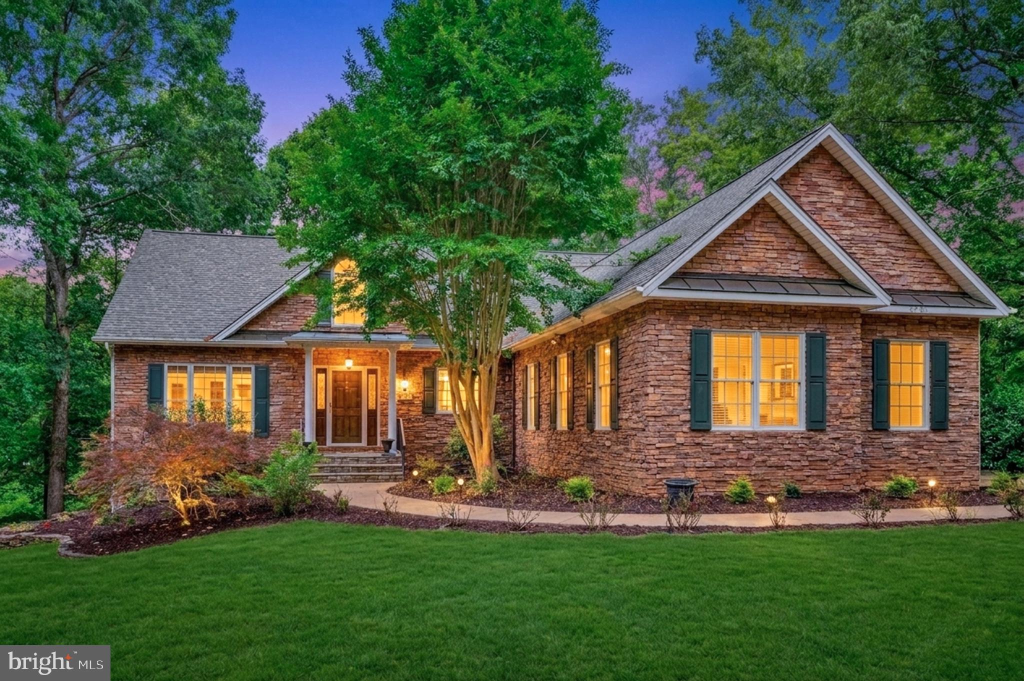 Set on scenic, park waterfront overlooking the lake, this home offers a peaceful retreat with the convenience of immediate lake access. Just a short walk from the backyard, a private community dock and swimming area on main water allow you to keep a boat nearby and enjoy spontaneous afternoons on the lake—whether boating, swimming, or simply soaking in the views.

Quaint from the curb yet surprisingly expansive inside, this custom rambler showcases timeless stone and vinyl siding and an interior filled with architectural detail and thoughtful craftsmanship. Cathedral ceilings create an open, airy feel throughout the home, complemented by hardwood flooring on the main level and LVP flooring in the walk-out lower level. Floor-to-ceiling windows in the living room, sunroom, and lower-level gathering spaces flood the home with natural light while framing peaceful lake views.

The kitchen is designed for both entertaining and everyday living, featuring granite countertops, custom cabinetry with distinctive accent details including a built-in wine rack, a center island, double ovens, and a dedicated desk or work area. It flows effortlessly into the main living spaces and outdoor entertaining areas, making it easy to host or relax.

The main-level primary suite offers a private retreat with a spa-like bath and direct access to a screened-in porch overlooking the water—perfect for morning coffee or evening unwinding. Multiple outdoor living spaces, including a rear deck and screened porches on both levels, invite you to enjoy lake breezes and sunset views year-round. An oversized two-car garage provides ample space for vehicles, storage, and all your lake essentials. A dual heating system with gas and electric adds efficiency, flexibility, and year-round comfort.

The fully finished walk-out lower level adds exceptional flexibility and opens directly to the waterfront. Designed for entertaining and extended stays, it currently accommodates a recreation room, additional dining area, pool table and office. Two lower-level bedrooms feature private exterior access, enhancing privacy for guests. Custom, hand-painted Italian Tuscany-inspired murals and arched walkways create a one-of-a-kind, warm ambiance—an artistic touch rarely found in homes at Lake Anna. An additional unfinished area offers generous storage or future customization.

With over 3,800 finished square feet, main-lake views, walkable access to a private community dock and swimming area, and spaces designed for both relaxed living and entertaining, this home delivers an exceptional Lake Anna lifestyle—comfortable, elegant, and full of surprises.

The sought-after Wyndemere subdivision offers exceptional amenities, including a private boat ramp, three community boat dock areas, tennis courts, a basketball/pickleball court, picnic areas, and common spaces at each waterfront location. Residents also enjoy a welcoming community atmosphere with neighborhood events and gatherings—making this the perfect year-round home or relaxing lake retreat.