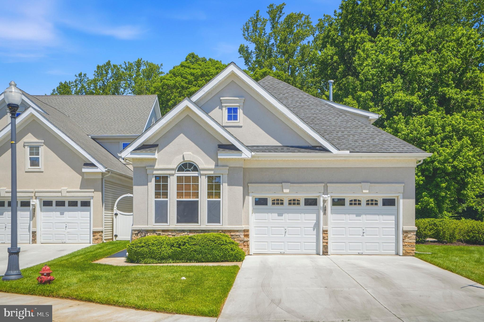 Welcome to this beautifully maintained home offering the perfect blend of comfort, space, and convenience. Nestled in a desirable community and backing to mature trees, this home provides a private setting while remaining close to everyday amenities. The spacious main level features an open and inviting floor plan with soaring ceilings, abundant natural light, and elegant living spaces designed for both everyday living and entertaining. The large kitchen is a true centerpiece, boasting extensive cabinetry, granite countertops, stainless steel appliances, tile backsplash, and a bright breakfast area. Adjacent to the kitchen, the dining room offers the perfect setting for gatherings, while the welcoming family room with a cozy fireplace creates a warm and comfortable place to relax. The main-level primary suite is a private retreat featuring a spacious bedroom, direct access to the rear deck, a large walk-in closet with custom organization, and a luxurious en-suite bath complete with a soaking tub, custom tile shower, dual vanities, and upscale finishes. Two additional bedrooms and a full bath provide comfortable accommodations for family and guests, while a dedicated office offers the ideal work-from-home space. Upstairs you will find a spacious bedroom with a walk in closet and full bathroom. The finished lower level dramatically expands the living space and includes a large recreation room, home theater area, additional family room, office space, and ample storage. Whether you're hosting movie nights, entertaining guests, or simply enjoying extra room to spread out, this level offers endless possibilities. Outdoor living is equally impressive with a spacious rear deck overlooking a peaceful wooded backdrop, perfect for morning coffee, outdoor dining, or relaxing evenings. The beautifully landscaped exterior, private patio, and low-maintenance yard create an inviting outdoor oasis. Combining spacious living areas, a desirable main-level primary suite, extensive finished lower-level space, and a tranquil outdoor setting, this exceptional home offers the lifestyle you've been waiting for.  Updates include HVAC (2021), Primary Ensuite Bathroom (2023), Deck Sliders (2024), Kitchen (2019). The community has it all with walking paths, a club house, gym, Tennis and Pickle Ball Courts and a Pool. Located in the heart of Pikesville, this home is just minutes from shopping, dining, Woodholme Shopping Center, and Woodholme Country Club, with easy access to I-695 for convenient commuting. Don’t miss the opportunity to own this meticulously maintained home in a highly desirable location!