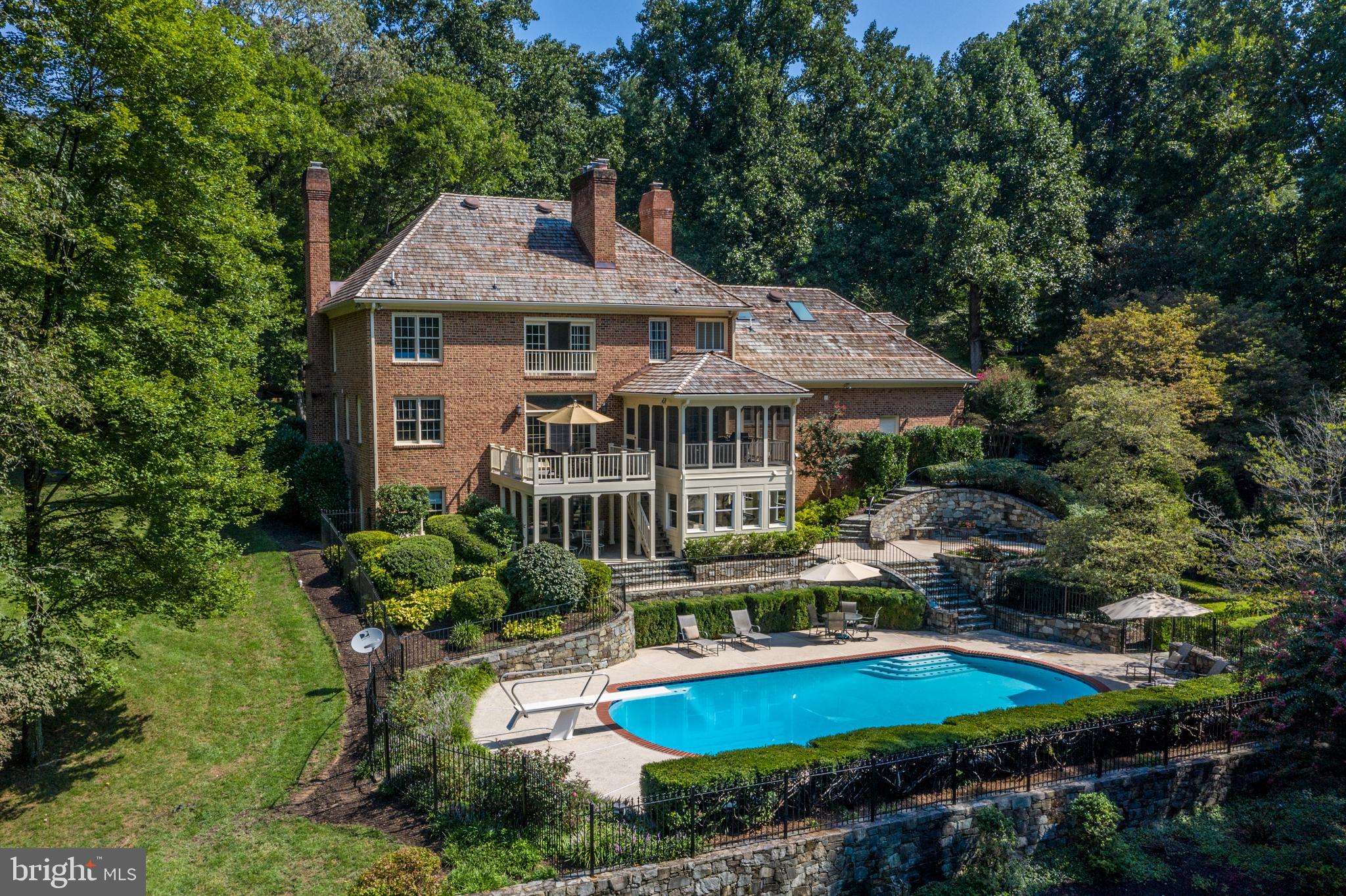 Why work from home when you can LIVE from home while you work? This all brick, custom built estate home features spectacular outdoor living space and two home offices! Retreat to the extra-large heated pool, custom built-in spa, amazing screened porch, brick pool house, open deck and expansive patio space all overlooking the nearly 3-acre lot surrounded by trees. A two-story foyer greets you with a curved staircase, hardwood floors and custom molding. The sunk-in family room is perfect for entertaining with a 10-foot ceiling, wet bar, recessed lights and stone fireplace with raised hearth & wood mantle, all steps from the open deck with beautiful vistas of the back yard. The kitchen is warm and inviting and features a double wall oven with separate warming drawer, center island with Viking downdraft 6-burner cook-top and breakfast bar.  In addition, the kitchen is flanked by a beautiful brick wall with gas fireplace and a perfectly placed sink overlooking the back yard. The formal dining room is freshly painted and accented by extensive molding and gas fireplace. The first of two home offices is located off the family room and is characterized by the rich mahogany wood of the built-in cabinets, book shelves and desk; and is steps from one of two powder rooms on the main level.  The second powder room is located off the second front door entrance foyer.  The lower level recreation room features a full bar with all the extras: kegerator, Scotsman ice maker, under-counter oven, microwave, dishwasher and wine cooler. All these luxuries surrounded by above grade windows for plenty of natural light, another brick wall feature, gas fireplace and walk-out doors to the patio overlooking the pool. The lower level also includes a "bonus" room great for guests. Across the hall is a full bath with shower featuring a "steam room" option. The second home office has windows on three sides which brings the outdoors in and provides enough space for a great home gym. On the upper level, the master bedroom offers a fabulous sitting room with  gas fireplace and wet bar overlooking the expansive back yard. The renovated master bathroom includes dual vanities, jetted tub & separate shower all accented by custom tile.  The upper level also offers three additional bedrooms, two en-suite & one with adjacent hall bath, all with generous closet space. This Ironwood custom built home has been enhanced with renovations by BOWA Builders and Case Design and topped off with a new cedar shake roof and copper plated flashings in 2019. All this just minutes to River Bend County Club. Welcome Home!