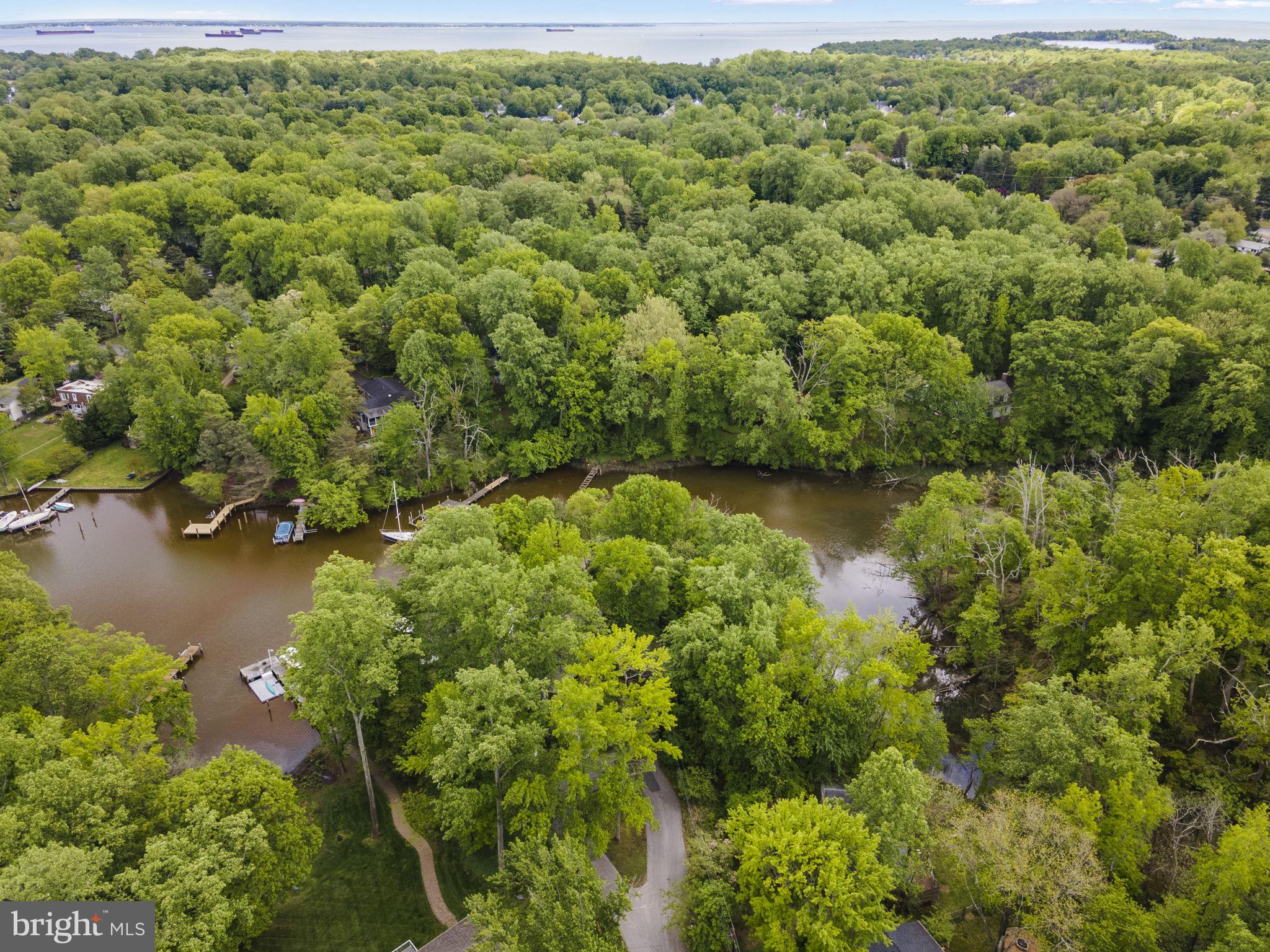 1009 Dulaney Lane in Annapolis, Maryland, offers a rare opportunity to build a custom waterfront home in the sought-after Annapolis Roads community. The 0.47-acre wooded lot is situated at the end of a quiet cul-de-sac, providing privacy and scenic views of Lake Ogleton. With 137 feet of waterfrontage, the elevated lot allows for the potential to maximize water views throughout the property.
Residents of Annapolis Roads enjoy community amenities such as a private beach, pavilion with fire pit, boat launch, pier, and walking trails. The location offers easy access to the Chesapeake Bay and is just minutes from downtown Annapolis, Eastport, and the U.S. Naval Academy. Commuters will appreciate the proximity to Route 50 and I-97, providing direct routes to Baltimore, BWI Airport, Fort Meade/NSA, and Washington, D.C. .
The lot is connected to public sewer, simplifying the building process. Potential buyers can bring their architect to design a peaceful waterfront retreat that takes full advantage of the natural surroundings and community features .