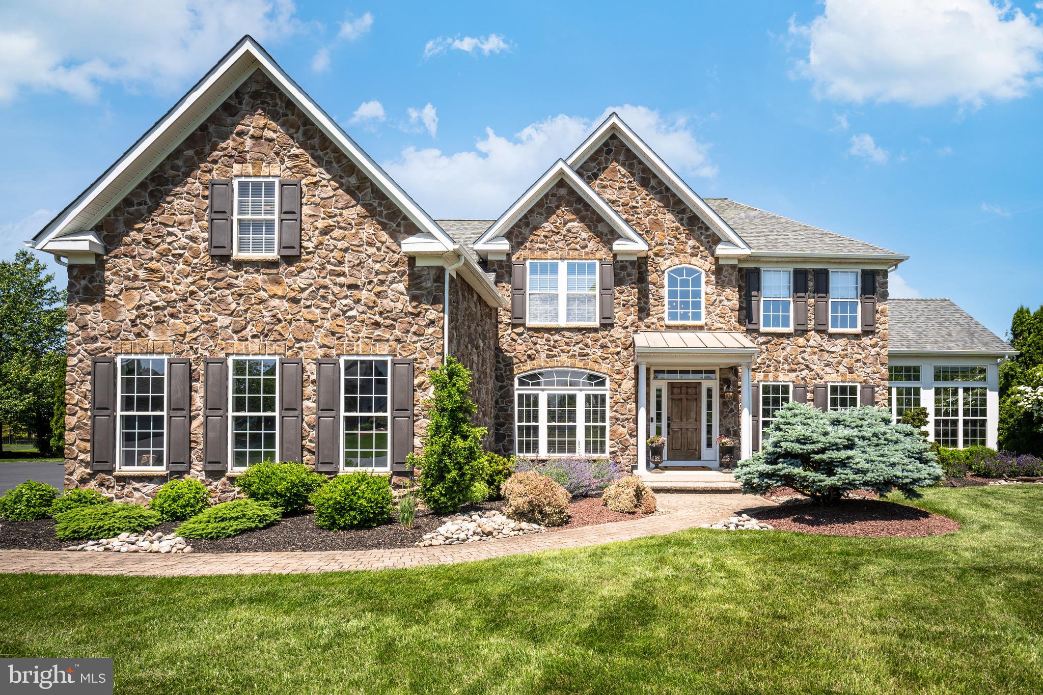 Multiple Offers Received. Please submit your Best & Final Offers by Sunday, 6/2 at 3 PM. Get ready to be impressed. Pride of Ownership is evident in this Stunning 4 Bedroom, 3 .5 Bath Colonial situated on a Premium Lot in the Exclusive Colt's Run Neighborhood of Lower Nazareth, Pennsylvania. Mature Landscaping and Premium Property Placement create a sanctuary of peace & privacy all year-round! Bonus - BRAND NEW ROOF & GUTTERS  installed Summer 2023. Beautiful stone & stucco accented exterior set the stage for quality - upon entering the Grand 2 Story Foyer, you're welcomed with neutral paint and beautiful wood floors flowing throughout the majority of the 1st Floor. Open Floor Plan greets you and leads you right into the Formal Living Room with recessed lighting and detailed wainscoting. Off the Living Room through French doors, large Conservatory has been transformed into a beautiful Bar Area with full custom bar with stone accent wall and mounted tv, granite countertops, space for pub style seating, tray ceiling, tile flooring, ceiling fan, and plenty of natural light - Perfect for Entertaining Family and Friends. Formal Dining Room boasts tray ceiling, wainscoting, and bay window. Moving into the breathtaking Eat-In Kitchen, enjoy oversized center island with quartz countertops and pendant lighting above, 42inch white cabinetry, tile backsplash, top of the line stainless steel appliances, custom built cabinetry-style range hood, and so much more. Large Sun-Soaked Breakfast Room overlooks the kitchen and features vaulted ceilings and views of the Backyard Oasis. Off the Kitchen, Two-Story Family Room boasts vaulted ceiling, beautiful stone fireplace with mantle, large windows bringing in natural light, & 2nd Back Staircase. Down the Hall, Office with glass doors and custom moldings creates the perfect space to Work From Home! Rounding out the 1st Floor is the Half Bath, Laundry Room with chevron tile floors, newer washer/dryer, utility sink, and oversized coat closet with custom shoe storage. Upstairs, hardwood floors continue to flow and lead you to the Grand Master Bedroom Suite which includes separate Sitting Area, Impressive Dual Walk-In Closets, and Private Updated Ensuite Master Bathroom. Master Bathroom has been recently remodeled and is sure to impress with two separate quartz-topped vanities, heated tile floors, large walk-in shower with frameless glass door enclosure, built-in shelving for all your cosmetics, + built-in bench, large soaking tub, linen closet, and separate water closet. Down the hall, 3 other generously sized Bedrooms are all in close proximity to the 2nd High-End Full Bathroom complete with double sink vanity, upgraded fixtures, and tiled tub/shower with glass door enclosure. No detail has been missed! Downstairs, in the Fully Finished Basement, hardwood continues to flow and features recessed lighting, neutral paint, and custom moldings + built-ins. Basement offers Large Great Room which creates a wonderful space to relax and unwind and includes bar area with built-in beverage fridge, egress window, and built-in entertainment center. Basement also features Workout Room & Carpeted Theatre Room with viewing screen and custom Murphy bed, Additional 3rd Remodeled Full Bathroom with walk-in shower with frameless sliding glass barn doors, and built-in shelving for all -perfect for entertaining guests! So much room to grow and create an additional family room, home gym, guest suite, etc - the possibilities are endless! Outside, the Backyard boasts extensive paver patio area, mature landscaping, Heated In-Ground Gunite Pool, Pool Shed w/electric, Covered Patio Area with stone accented gas fireplace, mounted tv + entertainment center, built in gas firepit, and plenty of grass area for other recreational activities! Backyard also includes outdoor kitchen area with granite countertops, built-in beverage fridge, and built-in grill. Perfect for those who love their vehicles - enjoy the oversized 3 Car Garage .