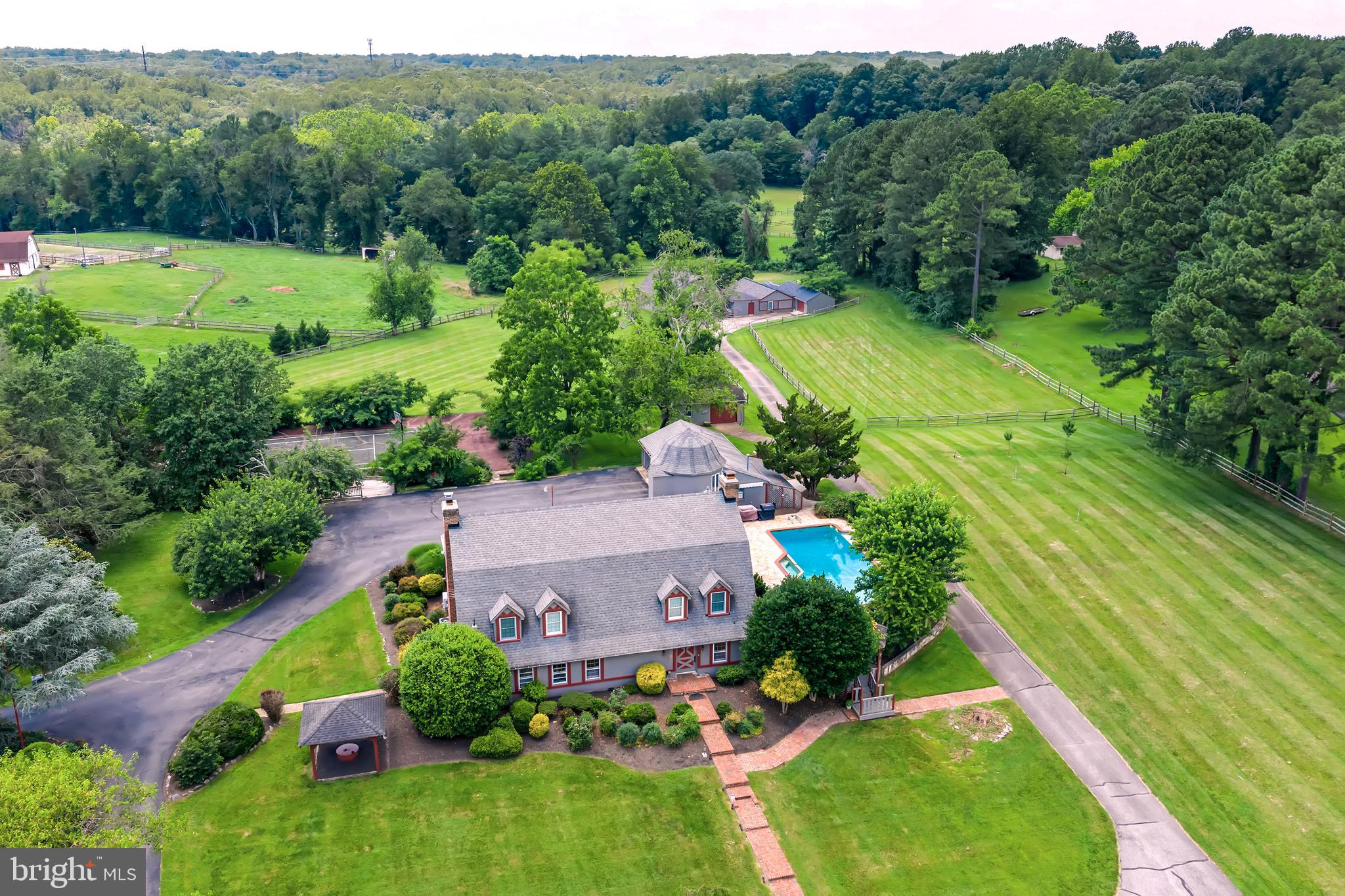 **Stunning 6-Acre Country Farmhouse Retreat**
Welcome to this exceptional countryside sanctuary where tranquility and rural charm meet modern comfort. Spanning approximately 6 acres, this captivating farmhouse offers a perfect blend of historic character and contemporary amenities — a true haven for those seeking peace, privacy, and natural beauty.
**Property Highlights: **
Originally a dairy farm dating back to 1940’s, the property has been lovingly expanded and updated, preserving its rustic appeal while integrating today's conveniences. This unique farm home is spacious with elegant living spaces: The home boasts approximately 5,414 square feet across two levels, featuring classic wood beams, brick accents, and an open-concept floor plan designed for both comfort and entertaining.
**Elegant Living room and Dining room**
Relax by the brick-surround gas fireplace amidst warm wood beams or enjoy birdwatching from the cozy sitting area. The combined open concept dining and game area provides ample space for gatherings and entertainment, making this home perfect for family and friends.
**The Gourmet Kitchen is a Chef’s Dream. **
The kitchen is equipped with stainless appliances, a 6-burner gas Dacor range with double ovens, a Sub-Zero refrigerator, a combination in-wall oven, warming drawer and microwave, custom cabinets, granite countertops, and hardwood flooring. Adjacent is a bright breakfast room, seating six comfortably, complemented by a charming coffee bar.
**A Grand Family Room for Family fun**
The newly renovated light and bright modern family room boasts custom built-in entertainment centers and cabinets  2 walls and new plush carpet.
**Three Main Level Bedrooms and more**
There are 3 main level bedrooms and 3 full baths. In addition, there is a private office or gaming room and a full laundry and mud room.
**Luxurious Master Suite**
Your own little slice of heaven is the magnificent master suite. Listen to nature in your private sleeping area. There is walk in closet and elegant master bath with a claw foot tub. And if that was not enough there is a 20 x 20 master suite sitting area, with a brick hearth and gas fireplace, flanked by walls of built in bookcases and enjoy looking up at the starry nights through the remote-controlled skylights.
***The Silo***
The renovated silo with its curved staircase with an abundance of light this could be an artist studio, study or a craft room.
*** Garden shed, stables, barn apartment, garage and outbuildings***
The converted barn apartment above the stables has soaring cathedral ceilings creating an open, airy atmosphere, and includes one and a half bathroom, a fully equipped kitchenette, a full laundry room, ideal for guests, staff, or rental income.
Outbuildings including stables, a garden shed, 3 zone climate-controlled storage, a professional workshop, a man cave with racks, for lumber—perfect for hobbies and outdoor entertaining.
**Outdoor & Lifestyle Amenities:**
 Swim and relax by in the Heated pool 
 Tennis courts reconfigured  into a basketball court
- Expansive 6-acre lot ideal for gardening, outdoor activities, or future development.
- Serene rural setting with picturesque views and abundant wildlife.
- Potential for equestrian pursuits, experience the many riding trails, farming, or simply enjoying the peace of country . 
2021- A generator for the main house 
  Despite its serene countryside location, you're just minutes from shopping, restaurants, Burke Lake Golf & Park, and key transportation options like the VRE, Springfield Metro, and major highways, making commuting and access to city convenient.
