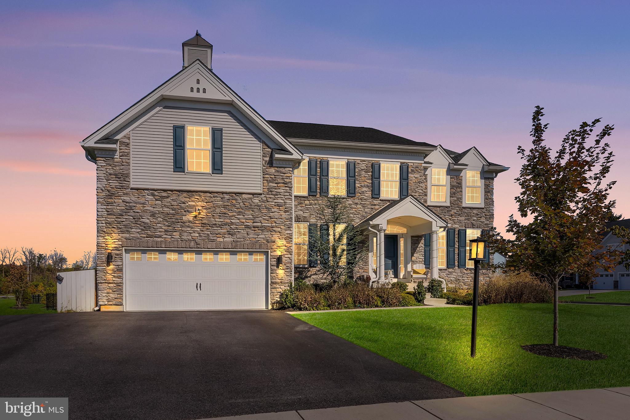 Why wait for new construction? Come experience this marvelous 2021 build in Malvern. Located within the Reserve at Great Valley, 10 Unison Dr is an exceptional five-bedroom, four-bath residence that delivers over 5,000 square feet of sun-drenched, impeccably designed living space. This home is enhanced by significant builder upgrades throughout, including a premium, extra-deep basement with nine-foot ceilings. Inside, discover a grand, light-filled foyer that welcomes you and flows seamlessly into an expansive open-concept living area designed for both everyday comfort and elevated entertainment. The focal point of the home is the custom gourmet kitchen, thoughtfully designed with a massive center island, U-shaped wraparound counters, and a full suite of stainless steel appliances, including double ovens and a gas range with hood. The gorgeous 42-inch soft-close cabinets provide excellent storage along with a sizable walk-in pantry. An abundance of windows floods this space with exceptional natural light, making the kitchen both functional and visually stunning. The adjoining great room impresses with dramatic 20-foot ceilings, a sleek gas fireplace, and a built-in bar, creating an ideal setting for hosting or relaxing in style. The dining area continues the sense of sophistication with a tray ceiling and a statement chandelier that anchors the space beautifully. A full bath and a versatile flex room with a closet complete the main level, offering the perfect setup for a guest suite or private home office. Upstairs, the primary suite serves as a true retreat, featuring a separate sitting area ideal for a nursery, den, or private lounge, along with two large walk-in closets. The spa-inspired primary bath includes dual vanities, a deep soaking tub, and an oversized walk-in shower. Three additional spacious bedrooms—one with its own ensuite bath—are joined by a central loft space and a convenient second-floor laundry room. The finished lower level further expands the home’s living space, highlighted by nine-foot ceilings, a versatile recreation area, a dedicated home gym zone, and ample storage space to meet a variety of lifestyle needs. Outside, pull into the spacious driveway, complemented by a two-car garage and an additional pad that comfortably accommodates multiple vehicles. The outdoor living area is equally impressive, with a professionally landscaped and fully-fenced yard that frames a 900-square-foot Trex deck topped with a premium pergola. This private, green setting provides an ideal backdrop for effortless alfresco dining, entertaining, or quiet relaxation. This community also features a mile-long trail and fully sidewalked streets. Located within the award-winning Great Valley School District, just minutes from premier shopping, dining, and major commuter routes, this home offers turnkey perfection in one of Chester County’s most sought-after enclaves. Schedule your private showing today—and bring your best offer!