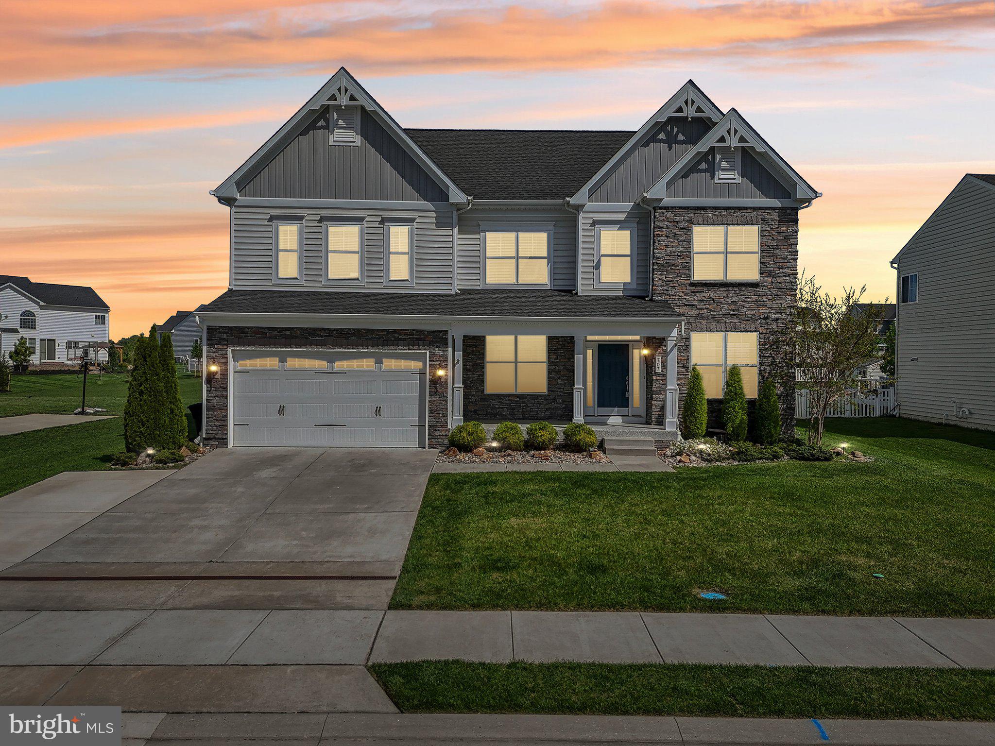 There is never a wrong time to buy the right home. Come see for yourself this amazing home in the highly sought after neighborhood of Magness Farms. This home has fantastic curb appeal with its beautiful color palette, stone accents, and covered front porch featuring an epoxy treatment. This property boasts a total of 6262 square feet and includes many desirable features such as 9-foot ceilings, crown moldings and wainscoting, 5-inch hand-scraped hickory wood flooring, and 35-inch high bathroom vanities. The home has a classic design throughout, a modern open living floor plan, and plenty of storage space. The stylish gourmet kitchen is equipped with 42-inch soft cream cabinetry, GE Profile stainless steel appliances, granite countertops, a generous island with a gas cooktop, double wall ovens, a subway tile backsplash, a walk-in pantry, and a convenient desk/family work center. You'll also find a light-filled sunroom. The impressive 2-story family room features the cozy ambiance of a gas fireplace with floor-to-ceiling stonework, a decorative mantle, and a coffered ceiling. There is a separate formal dining room, and French doors open to a versatile office/study/den. A spacious main-level in-law suite offers a walk-in closet and a full bath. The primary bedroom is a serene retreat with a tray ceiling and a walk-in closet, leading to a luxurious en-suite bathroom with an oversized custom shower, a private water closet, and a vanity with dual sinks. The upper level also includes three other spacious bedrooms and a laundry room with a large front-load washer and dryer, upper cabinetry, and a utility sink. The builder-finished lower level provides even more living space with a recreation room, a custom built-in wet bar, a bedroom with a sitting room, and a storage room with a sump pump and battery backup. There are also walk-up stairs to the outside. The property features extensive landscaping with river rock and a level rear yard with a lovely paver patio and fire pit, perfect for summertime entertaining and kids' play. The 2-car garage has a professional epoxy floor, and the driveway includes an extra side parking pad. Added upgrades include 2-inch faux wood blinds throughout the entire house, Nest thermostats, a wired alarm system, stone accents around the garage exterior entrance, and much more. The home is centrally located to downtown Bel Air, I-95, APG, schools, shopping, restaurants, and Wegman's. This is truly a place to call home.