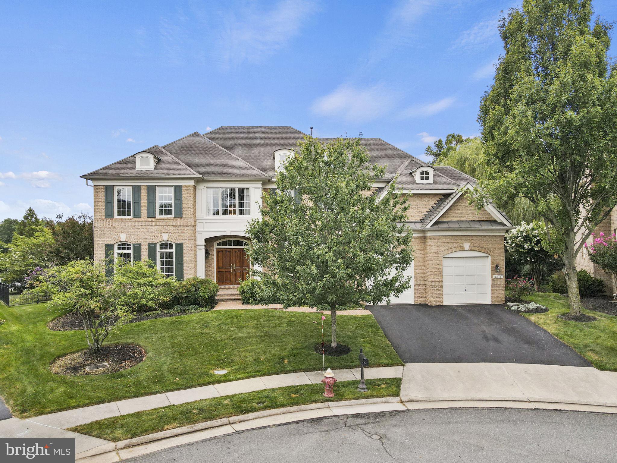Located in charming Brambleton community featuring two lovely waterfalls, miles of walking trails and a large central park. 42747 Mirror Pond is located on one of the most coveted lots in this community. This home backs to a large pond and a protected section of trees, all perfectly situated in a cul-de-sac. The stunning view can be enjoyed on the multi-level flagstone patio that includes a screened in porch and a grilling station that's perfect for entertaining. This four-side brick home is the perfect place to unwind at the end of the day, especially in the two-story family room while enjoying the gas fireplace in the cooler months. The view from the dining room is stunning and family gatherings will be enjoyed due to the large, upgraded gourmet kitchen featuring: Subzero refrigerator, Thermador 6 burner cook top, double oven, warming drawer, insta hot and in the butler's pantry a wine refrigerator. Many more upgrades abound in this beautiful home including tile kitchen flooring, tray ceilings and crown molding. Upgraded tile in all the bathrooms and upgraded cabinetry. The library features built in shelves and French doors to maintain privacy while working from home. Upstairs includes the laundry room to make everyday chores a breeze. The sizable primary suite features lovely views, sitting area and a balcony to enjoy morning coffee. The primary bathroom has a large soaking tub with jets and a shower stall. The princess suite is large and features its own private full bathroom. Two additional bedrooms and another full bath complete the upstairs. The basement is fully equipped for entertaining or having guests stay for the weekend. This ample space features a 5th bedroom, full bath and a kitchenette. There is plenty of storage and a gym room to make working out convenient. The garage has extra storage, and the generous shelves convey with the property. There is a place for everything!
