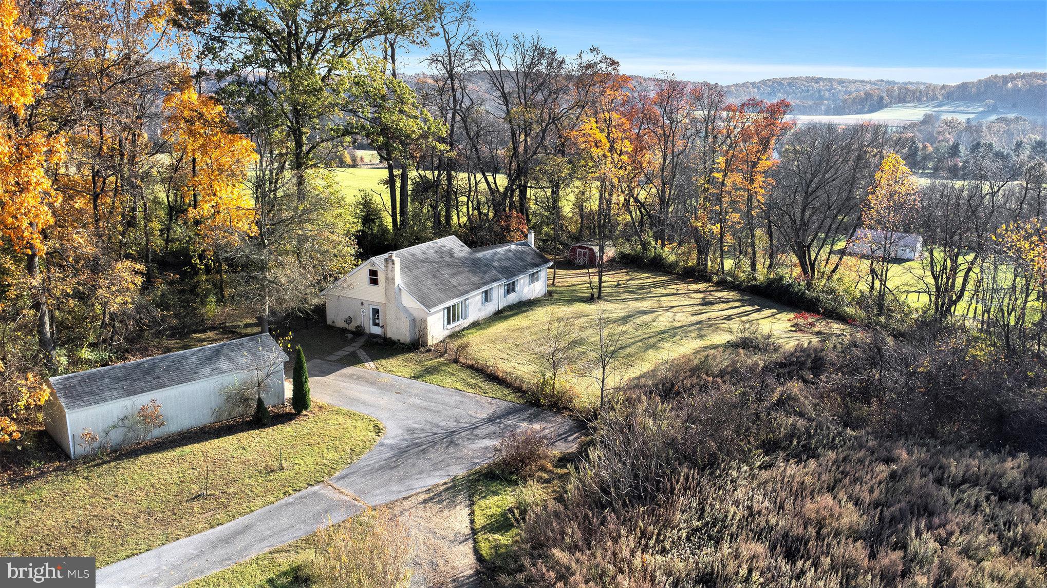 Welcome to this 1.2 acre secluded property with farmland views in South Coventry. Sitting at the end of a long driveway the home features a newer shed, parking area for a few cars and a fenced in yard. 
Inside you will find many updated features. The living room has a bay window and stone wood burning fireplace. The eat in kitchen offers an island with seating, recessed lighting and additional pantry cabinetry with a bench at the sliding glass door. Outside of the sliding glass door is a newer screened in gazebo. The main level also features two bedrooms and updated hallway bathroom with walk-in shower. The rear of the home has a huge family room with  a wall of shelves. Many closets throughout the home. On the main floor you will also find the utility closet with a brand new high efficiency HVAC (3/2023), newer water heater (2021) and the laundry area. Upstairs is the third bedroom and second full bathroom. Located right across the street from Hares Hill Brewing where they serve some amazing food and drinks. If you enjoy the outdoors Warwick County Park and St. Peters Village are a few miles down the road. Owen J Roberts School District.