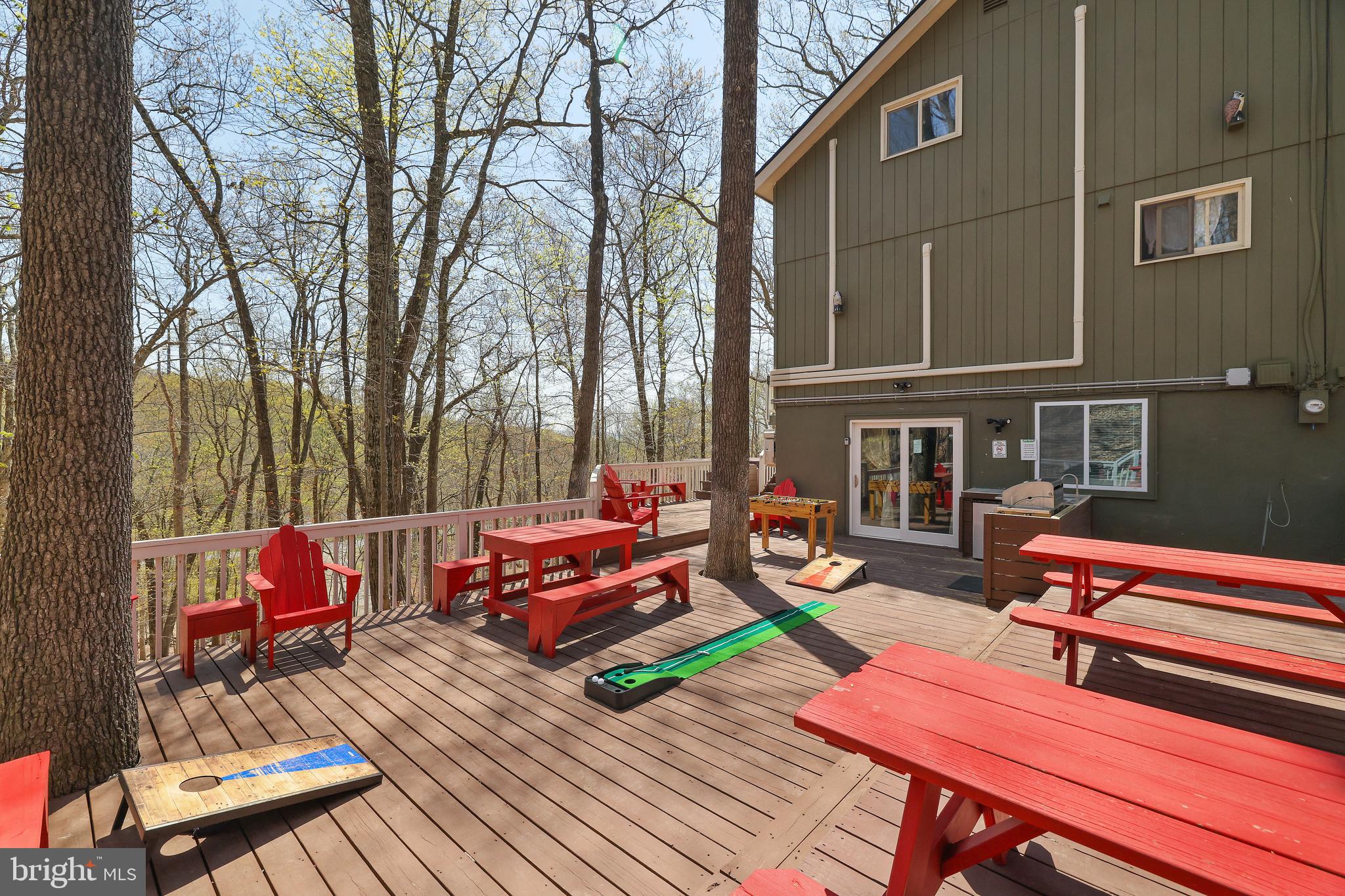 **Airbnb Monster or Unlock Your Dream Vacation Home** This remarkable short-term rental opportunity comes with a transferable permit and a location that truly inspires. Just 300 feet from the ski slopes, you are surrounded by adventure—Enjoy the restaurant, an Outdoor pool, an Indoor pool, Indoor Hot Tub and a Fitness center right at your doorstep. This 5-bedroom home offers breathtaking mountain views and a plethora of amenities. With a newer roof installed in 2020, the property features an outdoor hot tub, a generous deck, shed storage, an outdoor cooking station, and a large screened porch. The efficient split AC/heating system, two kitchens, expansive family room, and game room area enhance every moment spent here. The Primary bedroom with its balcony invites relaxation, while the wood-burning fireplace and exposed beam ceilings add warmth and charm, complemented by stainless steel appliances. Nestled in a vibrant four-season community, this home grants access to extraordinary amenities, including indoor/outdoor tennis courts, a tranquil beach area, fishing spots, boat rentals, racquetball, basketball courts, baseball fields, playgrounds, and seasonal ice skating. Seize this opportunity to make unforgettable memories—schedule your private viewing today.