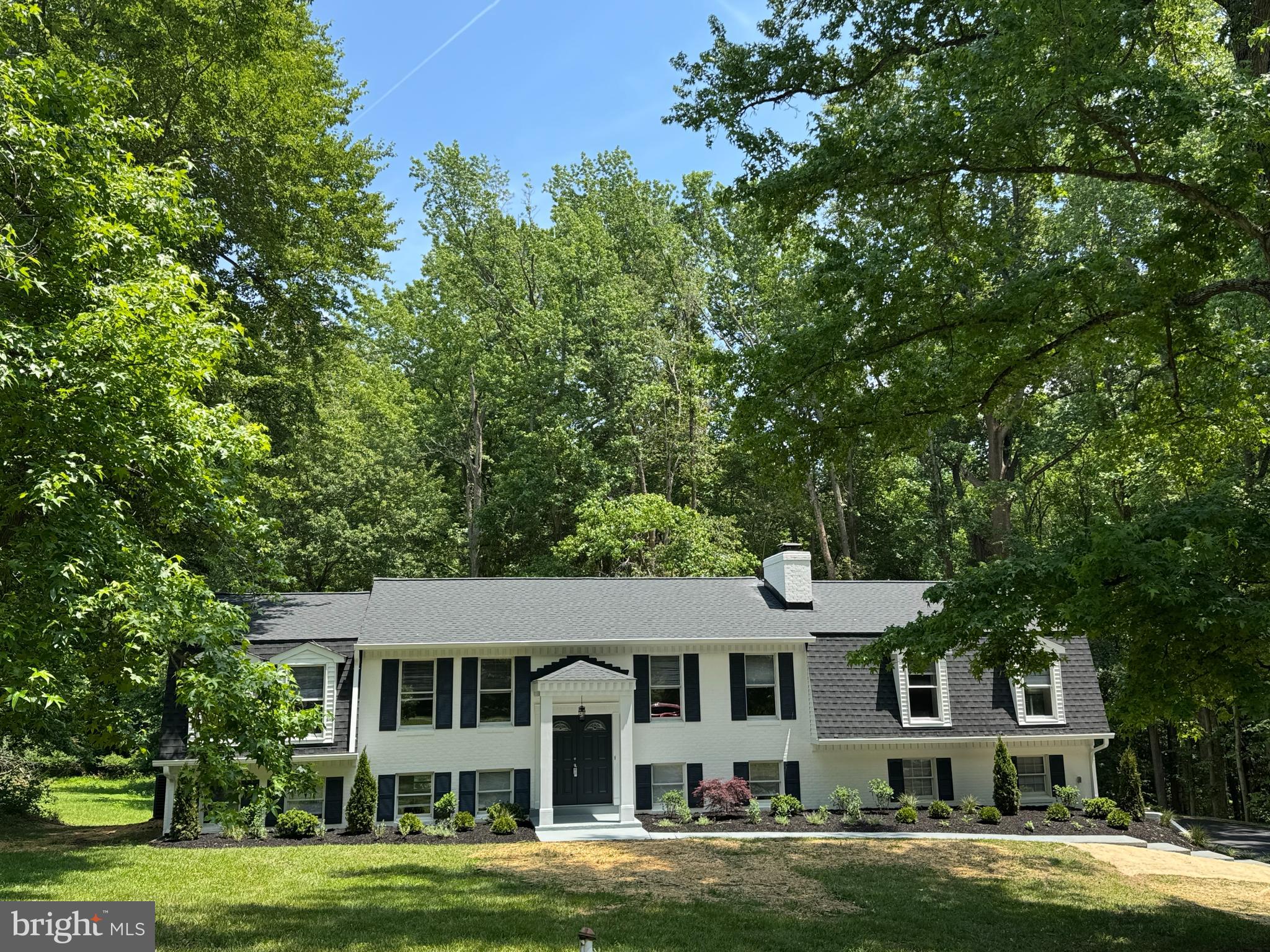 COMING ON MARKET 6/13.  PROFESSIONAL PHOTOS, VIDEOS, FLOORPLANS WILL BE UPLOADED TOMORROW.  OPEN HOUSE SUNDAY 1-3PM. SHOWN BY APPT. ONLY.
Welcome to 8855 Lowell Road — a stunning fully renovated residence located in the desirable Avon Crest community offering over $150,000 in high-quality improvements, luxury-inspired finishes, and exceptional multi-generational living flexibility rarely found in this price range.

Situated on a beautiful private 1-acre homesite backing to woods with mature trees and a large flat yard, this exceptional property offers the perfect balance of privacy, outdoor space, and sophisticated modern living.

Thoughtfully redesigned with timeless style and elevated finishes throughout, this move-in-ready home combines functional living spaces with luxury-inspired design. From the moment you arrive, the curb appeal is unforgettable with its freshly updated exterior, elegant black accents, designer lighting, manicured landscaping, and welcoming covered entry featuring dramatic double front doors.

Inside, the home has been extensively transformed with updated flooring, beautifully renovated kitchen and baths, contemporary fixtures, recessed lighting, fresh paint, and thoughtfully curated finishes throughout. The stunning open-concept kitchen features quartz countertops, modern cabinetry, stainless steel appliances, oversized seating and serving areas, and stylish black fixtures creating the perfect space for both entertaining and everyday living.

Multiple spacious living areas provide incredible versatility and comfort, including beautifully updated gathering spaces centered around a striking modern black brick fireplace that adds warmth, character, and architectural interest to the home.

A standout feature of the property is the expansive private lower-level in-law or au pair suite complete with two bedrooms, a beautifully updated full bath, kitchenette, large living area, and cozy wood-burning fireplace — offering exceptional flexibility for extended living arrangements, guests, private workspace, or multi-generational living needs.

Additional highlights include updated designer lighting, modern flooring throughout, beautifully renovated bathrooms, spacious bedrooms, dedicated flex/office space, and a large outdoor deck overlooking the peaceful wooded setting.

Ideally located in Pomfret, this exceptional Avon Crest property offers the perfect balance of privacy, recreation, and convenience with close proximity to shopping, dining, parks, commuter routes, La Plata, White Plains, and one of the area’s premier sports and recreation complexes.

Unlike many renovated homes, 8855 Lowell Road offers a true sense of quality, warmth, and craftsmanship rather than simple cosmetic updates. Homes with this level of renovation, setting, style, functionality, and turnkey condition rarely become available.