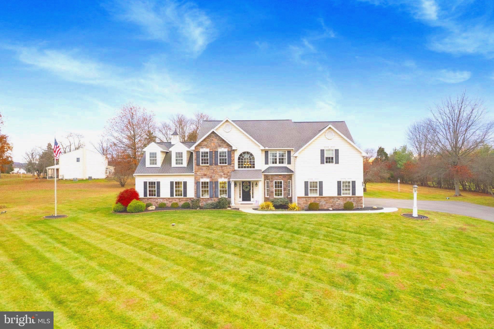 Set on a picturesque 2.82-acre private lot in the highly sought-after Methacton School District, this exceptional residence offers refined estate living just minutes from the shops, dining, and charm of Skippack Village. Built in 2010 and offered for the first time by its original owners, the home has been thoughtfully enhanced with two significant additions, expanding the finished living space to over 4,000 square feet above grade. 

The home’s timeless exterior—accented by classic stonework, dormers, and balanced architectural details—creates an immediate sense of arrival. Inside, a dramatic two-story foyer with a vaulted cathedral ceiling is anchored by a striking arched window that floods the space with natural light. Solid white oak hardwood floors, a grand front staircase with custom railings, and a secondary back staircase highlight the elevated craftsmanship throughout.

The formal dining room showcases a tray ceiling, wall sconce lighting, and custom millwork, while glass French doorsenhance architectural flow. A main-level office/study with bay windows and custom woodwork provides an ideal work-from-home retreat.

The sunken family room addition (2013) features a custom coffered ceiling, 10-foot ceilings, recessed LED lighting, and its own HVAC system. Sliding glass doors lead to the rear patio, creating seamless indoor-outdoor living. The family room is centered around a gas fireplace framed by a dramatic floor-to-ceiling stone wall.

Completed in 2020, the sunroom addition is filled with large Andersen windows and dual sliding glass doors, flooding the space with natural light and offering beautiful views of the private 2.82-acre setting—a perfect place to enjoy all four seasons.

The gourmet kitchen features stainless steel appliances, 42-inch cabinetry with integrated lighting, granite countertops, and stainless steel appliances.

Key systems and features include: two HVAC systems with three-zone climate control, a main home system updated in 2024, 300-amp electrical service, Andersen double-hung tilt windows and doors, and a basement with 9-foot ceilings, egress window, and three sump pumps.

The basement offers exceptional potential with high ceilings and Bilco doors for easy exterior access to the backyard. The expansive open layout is ideal for a home gym, kids’ play area, or future finished living space. An additional room with a ground-level window brings in natural light and adds flexibility for storage, office, or hobby use.

Meticulously maintained and thoughtfully upgraded, this remarkable residence delivers timeless luxury, exceptional craftsmanship, and an unbeatable location—presenting a rare opportunity to own a truly special estate property in one of the area’s most desirable settings.
