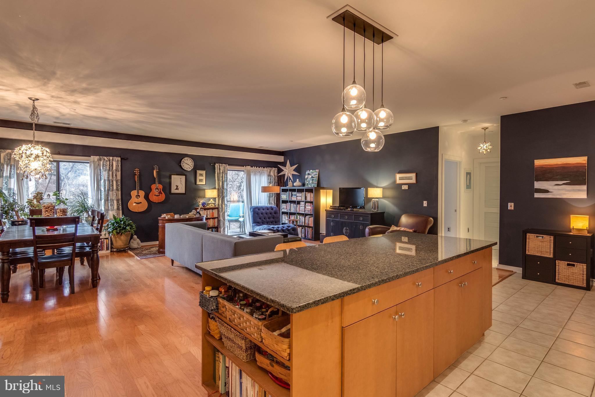 Spacious and bright this stylish 2BR, 2BA condo features a huge kitchen island with granite and SS appliances and an open floorplan. Balcony & windows overlook woods and creek. 2 garage spots and an awesome outdoor pool scene are delightful amenities. Light Rail just steps from condo. Convenient for walking & biking to shops and restaurants in Woodberry/Clipper Mill, Hampden, & Mount Washington.