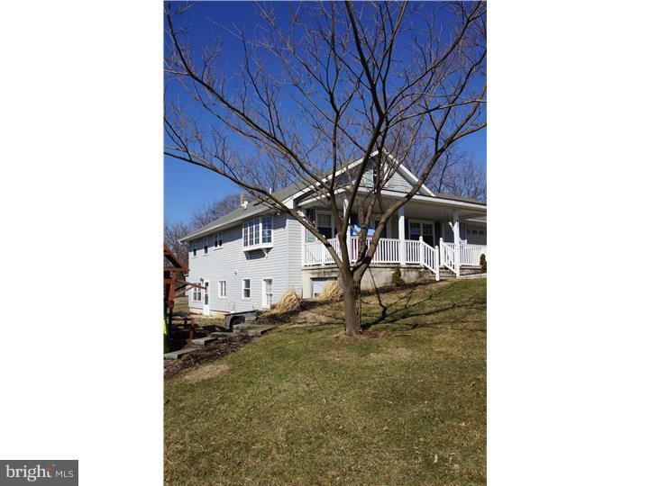 Come see this nice home that sits on a little over an acre of land! Enjoy a beautiful view from bay window in the living room or front porch. Relax in the Jacuzzi tub while looking out one of two skylights. Plenty of room in the two large bedrooms on main level. Don't feel like doing laundry in lower level, separate hook ups in hall bath. Windows abound in lower level walk out  in-law suite/apartment. It has it's own entrance, bed, bath with laundry, family room and kitchen. Two stove pipes in lower level to add your own wood/pellet/coal stove for a warm and toasty winter. One car attached garage and shed out back for lawn equipment. Set up your private showing today.