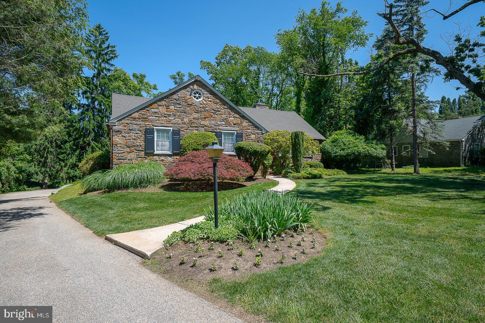 Welcome to this spacious 3 bedroom, 2 full bath home ,situated on an acre property on a quiet tree lined street in the highly desirable Penn Valley neighborhood of Lower Merion School District. This home offers a rare combination of character, functionality and opportunity. Step into the welcoming foyer. To the right you'll find an expansive living room drenched in natural light on two sides with a beautiful gas fireplace. The living room flows into a large sunlit dining room with hardwood flooring. Beautiful hardwood flooring is located under all carpeted areas of the entire first floor. A cozy den/office with wet-bar and access to the rear yard is located off the living room. The updated, eat in kitchen ,with access to the rear yard is located in the center of the home next to the dining room. The spacious primary suite offers a full wall of custom built in 
closets, 2 additional closets, and a recently renovated bath with stall shower.
Two additional bedrooms and a spacious updated hall bathroom complete this level. 
The attic is partially finished with flooring and a bathroom. This level offers plenty of storage and endless possibilities for expansion. Laundry is located in the unfinished lower level.  This expansive space with walk out access to the rear yard also provides abundant storage and exciting potential for future finishing to create additional living or recreational space. Enjoy the tranquility of the spacious yard from the covered patio. The separate 2 car garage is located behind the house with easy access to the lower level. The generator offers peace of mind &  convenience. The newer roof was replaced in 2024. Ideally located just minutes from major roadways for easy access to Center City.