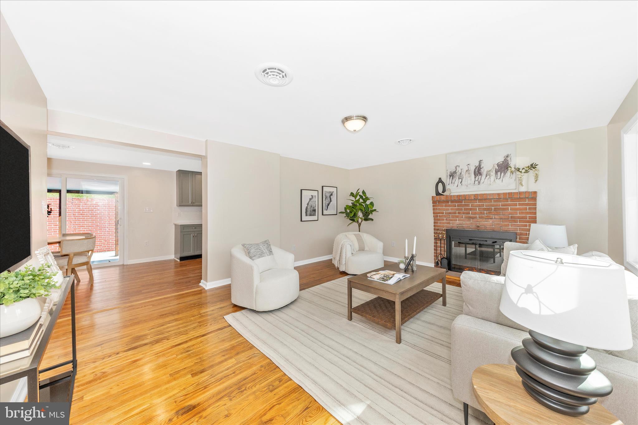 This charming ranch-style home, built in 1965 and completely renovated in 2025, offers a perfect blend of classic comfort and modern updates. With 1,425 sq. ft. of thoughtfully designed living space, this residence features three inviting bedrooms and two full bathrooms, including a primary bath that promises a serene retreat. The heart of the home is the family room, seamlessly connected to the kitchen, making it ideal for gatherings and everyday living. Enjoy the warmth of wood floors and a cozy fireplace that adds a touch of elegance to the space. Step outside to a generous 0.56-acre lot, where you can relax on the brick patio under the awning, perfect for outdoor entertaining or quiet evenings. The attached carport provides convenient parking, ensuring your vehicles are protected year-round. Located in a vibrant community, this home is surrounded by excellent schools, lush parks, and convenient public services, making it an ideal place to settle down. The neighborhood boasts a friendly atmosphere, with local shops and dining options just a short drive away. This property is less than two minutes away from I-70, making it easily accessible to major commuter routes. Embrace the lifestyle this home offers, where comfort meets community, and every day feels like a retreat. Don't miss the opportunity to make this delightful property your own!