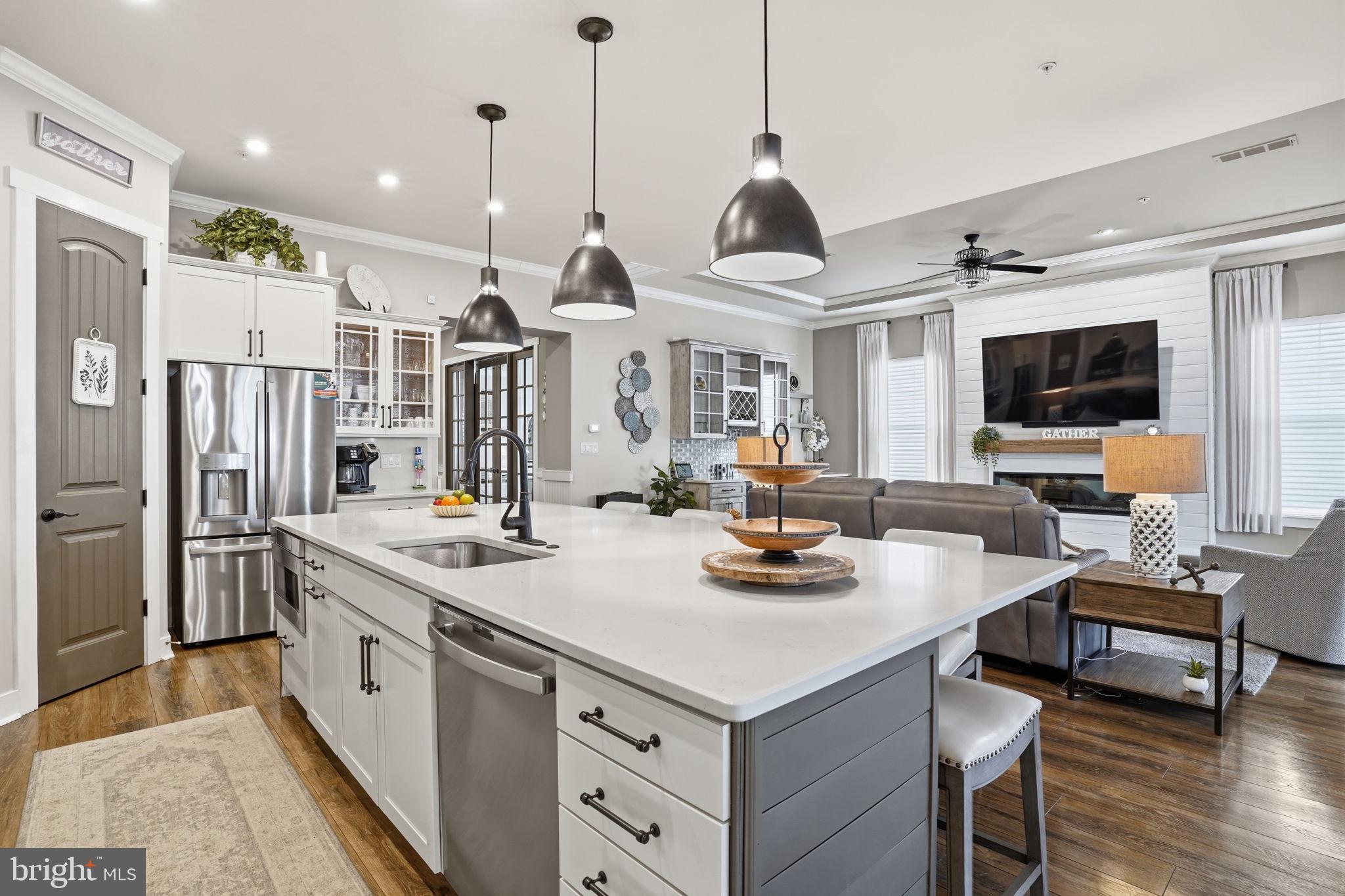 Welcome to 129 Sailcloth Way in the resort-style community of Four Seasons at Kent Island!  This beautifully upgraded Kilarney model offers over 2300 square feet of single-level living, an open layout, and designer finishes throughout.  Move-in ready and available now - no need to wait months for new construction.
Inside, you'll find a spacious gourmet kitchen with GE Profile appliances, gas cooktop, double oven, quartz countertops and backsplash, a large island, under-cabinet lighting, and a convenient wine bar.  The kitchen flows seamlessly into the bright dining area and the expansive great room with a gas fireplace, creating the perfect space for everyday living and entertaining.
This home includes 2 bedroom, 2 full baths, and a flex room idea for a home office or a third bedroom.  The impressive owner's suite features a walk-in closet, and a private bath with a quartz-topped double vanity.
Additional upgrades include custom window treatments, upgraded lighting, and an oversize garage that is insulated, as well as a finished and insulated attic - all already installed, saving you thousands compared to new construction.
Four Seasons at Kent Island offers exceptional amenities, including a brand-new 24,000 sq. ft. clubhouse overlooking the Chester River, outdoor infinity pool, indoor pool, fitness center, game room, library, fire pits, Tiki bar, walking paths, pickleball and tennis courts, bocce, dog park, amphitheater, and pier with transient boat slips.  A full-time lifestyle director coordinates daily activities, clubs, classes and community events year-round.  Experience true resort-style living on Kent Island!