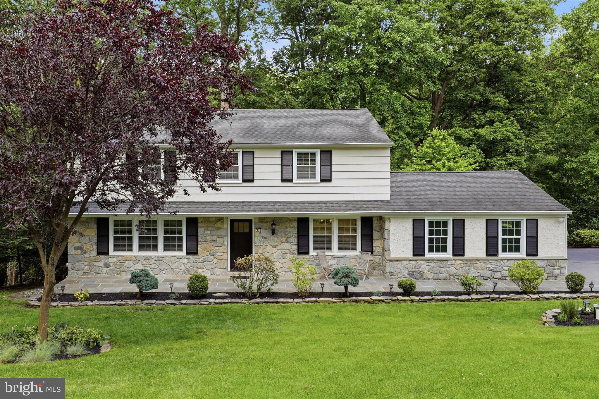 Welcome to this beautifully updated Colonial, situated on a private 1.2-acre lot near the end of a quiet cul-de-sac in desirable Malvern. Located within the highly regarded West Chester Area School District, this four-bedroom, two-and-a-half-bath home blends timeless character with thoughtful modern upgrades and exceptional indoor-outdoor living.

A charming covered front porch welcomes you into the center hall foyer. The spacious living room flows seamlessly into the inviting family room, featuring a wood-burning fireplace, custom built-in shelving, and French doors leading to the expansive rear deck. The formal dining room is conveniently positioned off the foyer and connects directly to the heart of the home—the beautifully remodeled kitchen.

Designed with both style and function in mind, the custom kitchen showcases Amish-built inset cabinetry, abundant storage, an appliance garage, oversized windows overlooking the backyard, a Thermador 36" Pro Grand professional range, and a suite of high-end appliances. A convenient butler's pantry provides additional storage and workspace while connecting the kitchen to the remodeled laundry room. As part of the renovation, the main level was thoughtfully reconfigured to create a more open and functional layout, complemented by wide-plank white oak hardwood flooring throughout.

Upstairs, the spacious primary suite serves as a private retreat and features a beautifully renovated en-suite bath with heated marble floors and premium Perrin & Rowe fixtures. Three additional generously sized bedrooms share a stylishly updated hall bath featuring a Kohler tub and Brizo hardware.

One of the home's standout features is the exceptional outdoor living space. The expansive deck offers outstanding space for entertaining and everyday enjoyment. A large covered section features a vaulted ceiling, ceiling fan, lighting, and tranquil wooded views, creating the perfect setting for relaxing or hosting guests throughout the seasons.

The fully finished walk-out lower level provides flexible living space ideal for a recreation room, home office, fitness area, or guest retreat, and includes a bonus room currently used as a wine room.

People are drawn to this highly desirable neighborhood, where homes rarely become available. East Goshen Park is also just a short walk away and features a large playground, tennis and pickleball courts, basketball courts, walking trails, and more.

Additional highlights include a two-car side-entry garage, an expansive driveway, and numerous quality improvements throughout the years, including high-efficiency heating and cooling systems, upgraded exterior doors, and thoughtfully designed landscape enhancements.

Combining quality craftsmanship, extensive updates, and a beautiful private setting, this exceptional property offers the perfect blend of classic Colonial charm and modern comfort.