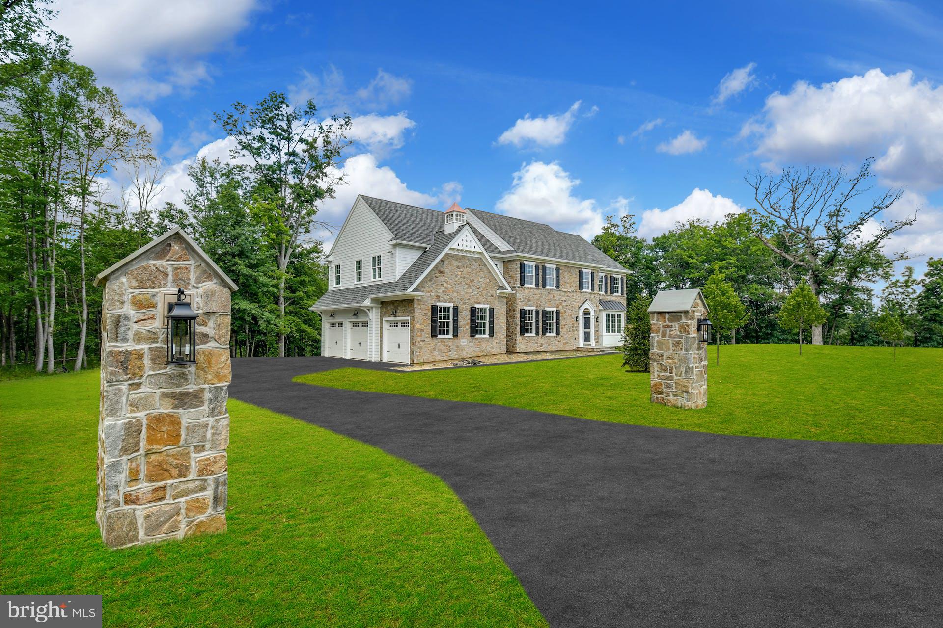 Luxury new construction without the wait! A Classic Farmhouse exterior with Bucks County Fieldstone blends seamlessly with an interior boasting all the modern amenities you want in a home! Tranquility awaits as you take in the sights and sounds of nature, from the soothing water trickling in the creek to the deer, red fox and hawks roaming in your private retreat. Bucks County craftsman Andrew Lykon of Lykon Custom Builders creates an exceptional living environment where form and function coexist with value and a timeless aesthetic.  This custom home on 10+ acres has approximately 4200 SF of elegant and thoughtful living space. 9 ft ceilings on all levels, wide plank hardwood floors throughout, custom millwork, crown moldings and raised panel wainscoting create an air of sophistication. The stone entry piers make a grand statement as you approach the home and the welcoming Portico with custom arched door and 2-story foyer graciously greet your guests. The open floor plan is an entertainer’s dream and flows easily from one room to the next. You will love cooking from the Chef’s Kitchen complete with expansive, Quartz-island, luxury appliance package and wet bar.  Take in the serene views of nature while enjoying your morning coffee from the fabulous Morning room with vaulted ceiling and walls of windows. The Great room with coffered ceiling features a full-height stone fireplace with beamed mantel, flanked by 8 ft Anderson sliding doors to the TimberTech Deck - the perfect spot for dining alfresco or relaxing in the sun. Host holiday gatherings in the elegant Dining Room with plenty of room to seat large parties. The Living room allows for additional entertaining options and the Study provides a peaceful space to work from home. This is truly Country Living at its Finest! The impressive turned staircase leads you to the second floor with a gallery hallway that adds a decorative touch. The luxurious Primary bedroom suite with vaulted ceiling boasts two generously sized walk-in closets and a large ensuite bathroom complete with dual vanities with quartz counters, dual toilets; a relaxing, freestanding soaking tub; walk-in shower with dual rain heads and controls, and radiant heat under the porcelain tile floor. The attached sitting area allows for an optional guest room or second study. Bedroom One has an ensuite bathroom, Bedrooms Two and Three share a connecting bathroom and all have walk-in closets. Convenient second floor laundry room. The daylight, walk-out basement has room for a home gym, storage, or additional entertaining options and provides easy access to your scenic backyard oasis.  Feel yourself exhale – you are home! There is the potential to add an accessory building, such as a She-Shed, Art/Music Studio or Pole/Horse Barn.  Plenty of land for pastures with potential to house horses or other livestock.   Builder warranty included. Plumstead township is a hidden gem in Bucks County, close to everything and yet tucked away to provide the peace and privacy you value.  The quaint and historic towns of New Hope and Doylestown are a stone's throw away with wonderful restaurants and entertainment venues. Easy commute to New York, New Jersey, or Philadelphia. Award-winning Central Bucks School District. With the 10.53 acre parcel there may be potential for preferential taxation under Act 319.  Contact listing agents to request Spec Sheet with details.
