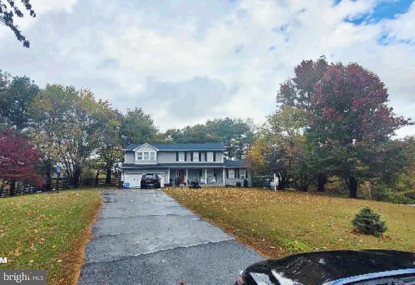 Discover the charm of this colonial-style home, nestled on a generous 1.05-acre lot in Calvert County. With 2,883 square feet of thoughtfully designed living space, this residence features five spacious bedrooms and four and a half bathrooms, ensuring ample room for relaxation and privacy. The home's layout is perfect for both entertaining and everyday living, with a seamless flow between rooms. Outside, the expansive rear yards are adorned with mature trees, creating a serene backdrop for outdoor activities or peaceful retreats. Enjoy your morning coffee on the charming porch or host summer barbecues on the spacious deck, perfect for soaking in the beauty of nature. The property also features a two-car attached garage with a front entry, complemented by a paved driveway for added convenience. Enjoying the lush surroundings and the tranquility that comes with this beautiful setting!