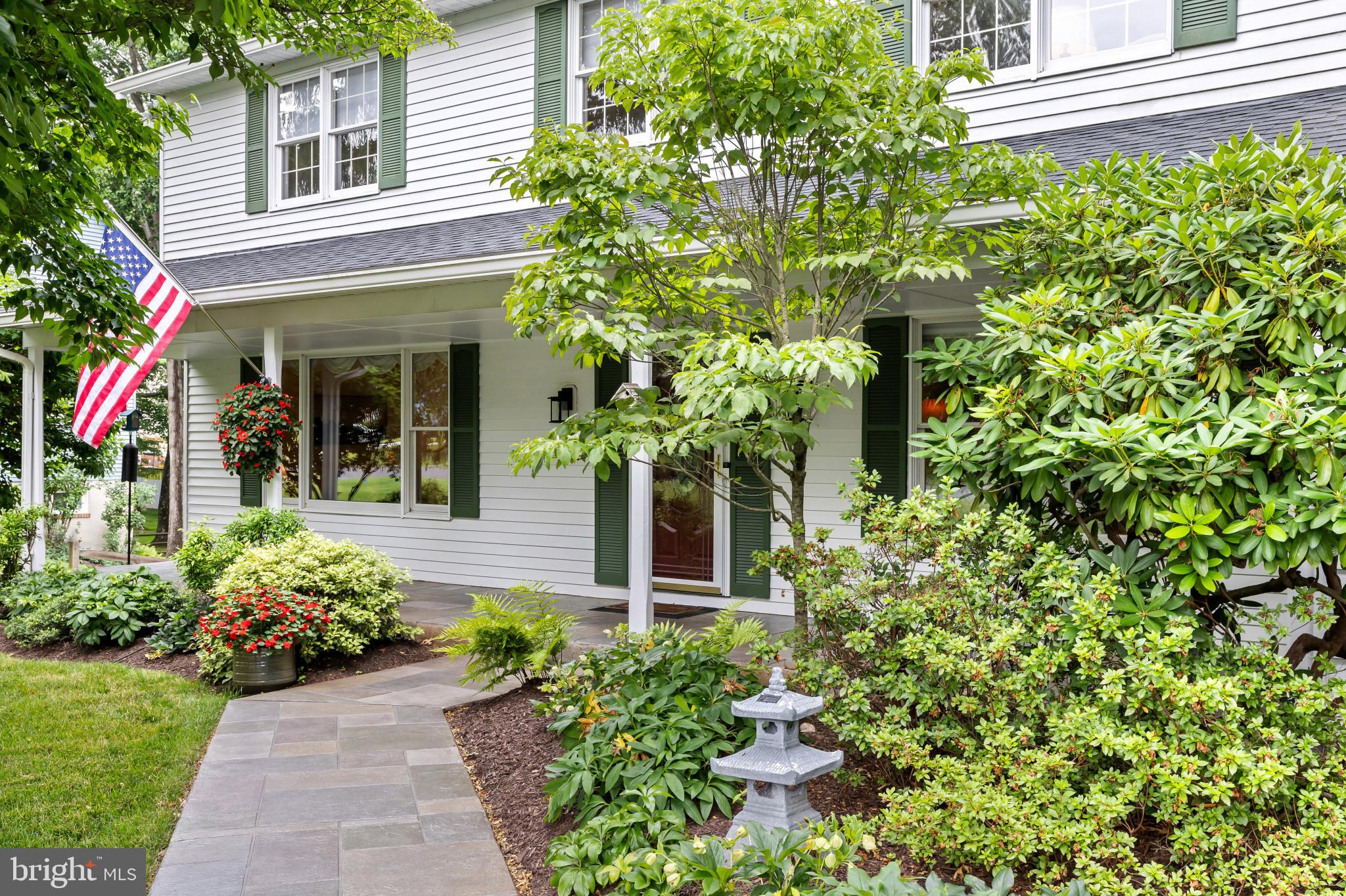 Charming Colonial residence offering 4 bedrooms, 2.5 bathrooms, 2,590 finished square feet, and an oversized 2-car garage, lovingly maintained by the original owners and nestled on a breathtaking lot in picturesque Chateau Valley. Surrounded by mature trees and established landscaping, this home combines timeless character and comfortable living spaces. // A spacious covered front porch framed by lush landscaping welcomes you inside, where slate flooring greets you in the foyer. Rich hardwood floors extend throughout the sunlit living room and continue seamlessly into the formal dining room, elegantly appointed with decorative upper-wallpaper accents, chair railing, and a classic chandelier, creating a warm and inviting setting for entertaining. // The eat-in kitchen is thoughtfully designed with stainless steel appliances, Corian countertops, a custom backsplash, and ample workspace for meal preparation. Adjacent to the kitchen, the bright breakfast room provides convenient access to a screened porch, making indoor-outdoor entertaining effortless. // The inviting family room offers a comfortable retreat, highlighted by plush carpeting and a stunning floor-to-ceiling brick wood-burning fireplace that serves as the focal point of the space. A nearby laundry room and powder room, both featuring luxury vinyl tile flooring, complete the main level. // Upstairs, the spacious owner's suite features a walk-in closet and a private ensuite bathroom. Connected to the primary suite is a versatile secondary bedroom, ideal as a sitting room, nursery, or home office. Two additional generously sized bedrooms and a full hall bathroom complete the upper level. The walkout lower level provides endless possibilities, offering abundant storage space or a blank canvas ready for future customization to suit your needs. // Outdoor living is truly exceptional. An enclosed screened porch with vaulted ceilings, skylights, and a ceiling fan creates the perfect setting for relaxing while enjoying views of the surrounding landscape. The porch opens to a tiered Trex® composite deck featuring a built-in bench seat and pergola overhead, ideal for outdoor dining and entertaining. Beyond, the expansive fenced backyard is surrounded by mature trees and lush landscaping, creating a private and picturesque outdoor retreat.