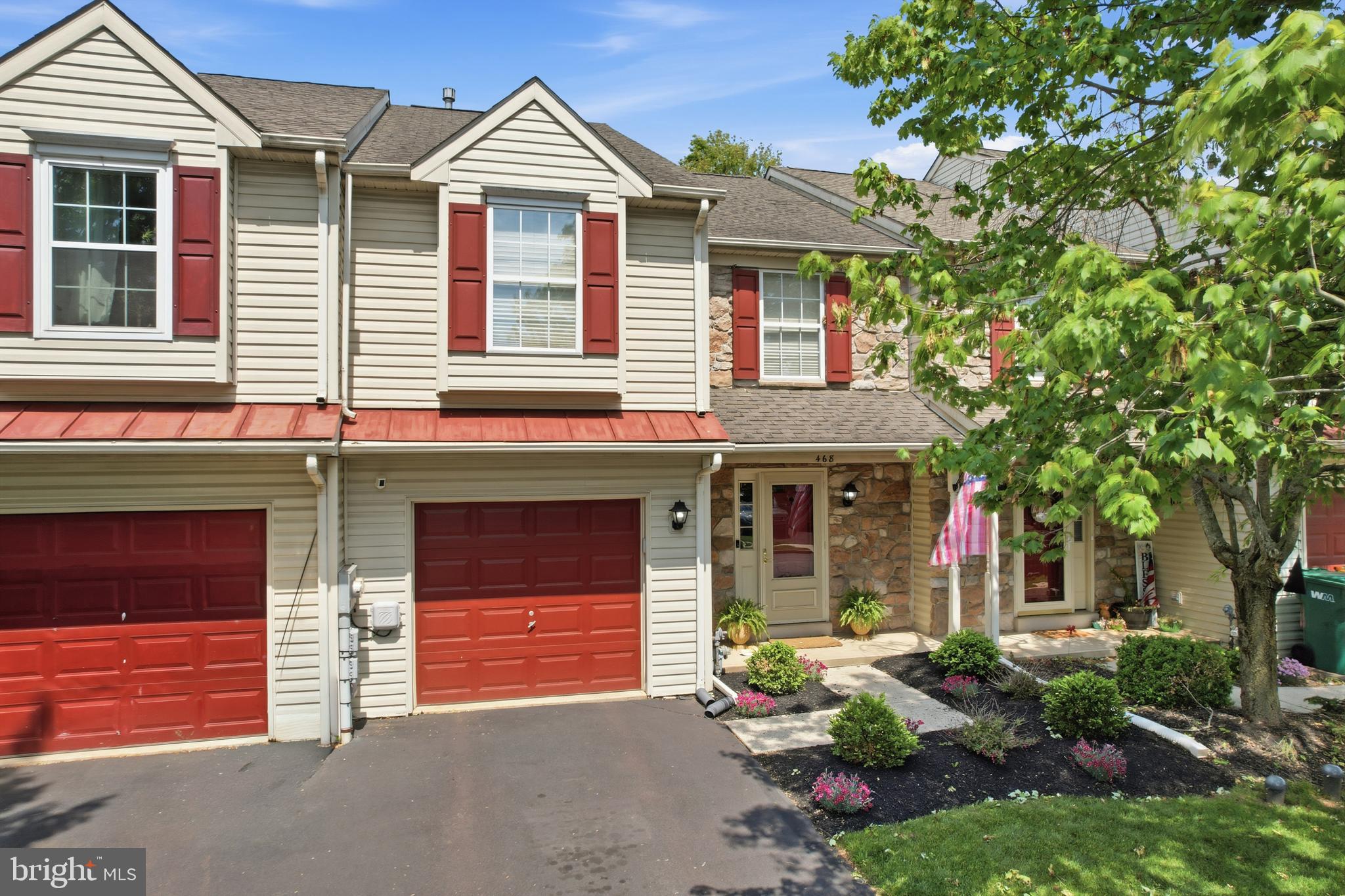 Welcome to Banbury Crossing — where this exceptional townhome stands out from the rest! Built by renowned builder Garis Homes, this beautifully maintained residence offers an open and inviting floor plan with 3 spacious bedrooms, 2.5 baths, and a stunning finished basement adding approximately 400 sq. ft. of additional living space. Step inside to a welcoming foyer with oak hardwood flooring and a convenient powder room, leading into the open-concept kitchen, dining, and family rooms — a layout designed perfectly for both everyday living and entertaining. The spacious family room features a beautiful bay window that fills the home with natural light, while sliding doors provide easy access to the composite deck and lush backyard, ideal for relaxing or hosting guests. The kitchen is both stylish and functional, featuring raised oak cabinetry, stainless steel appliances, abundant storage, and a pass-through to the dining area. Recessed lighting, ceiling fans, and tasteful finishes throughout create a warm and polished feel. Upstairs, you’ll find a convenient second-floor laundry area, two generously sized bedrooms, a full hall bath, and a spacious primary suite complete with a walk-in closet and separate vanity area. The finished basement offers additional flexible living space with laminate plank flooring, perfect for a media room, home office, gym, or playroom, along with extra storage space. Pride of ownership is evident in every detail of this meticulously cared-for home.  Located in the desirable Banbury Crossing community of Franconia Township, residents enjoy charming lamp posts, sidewalks, nearby walking trails, and convenient access to downtown Souderton shops and restaurants, Routes 309 & 113, and the Lansdale Northeast Extension.