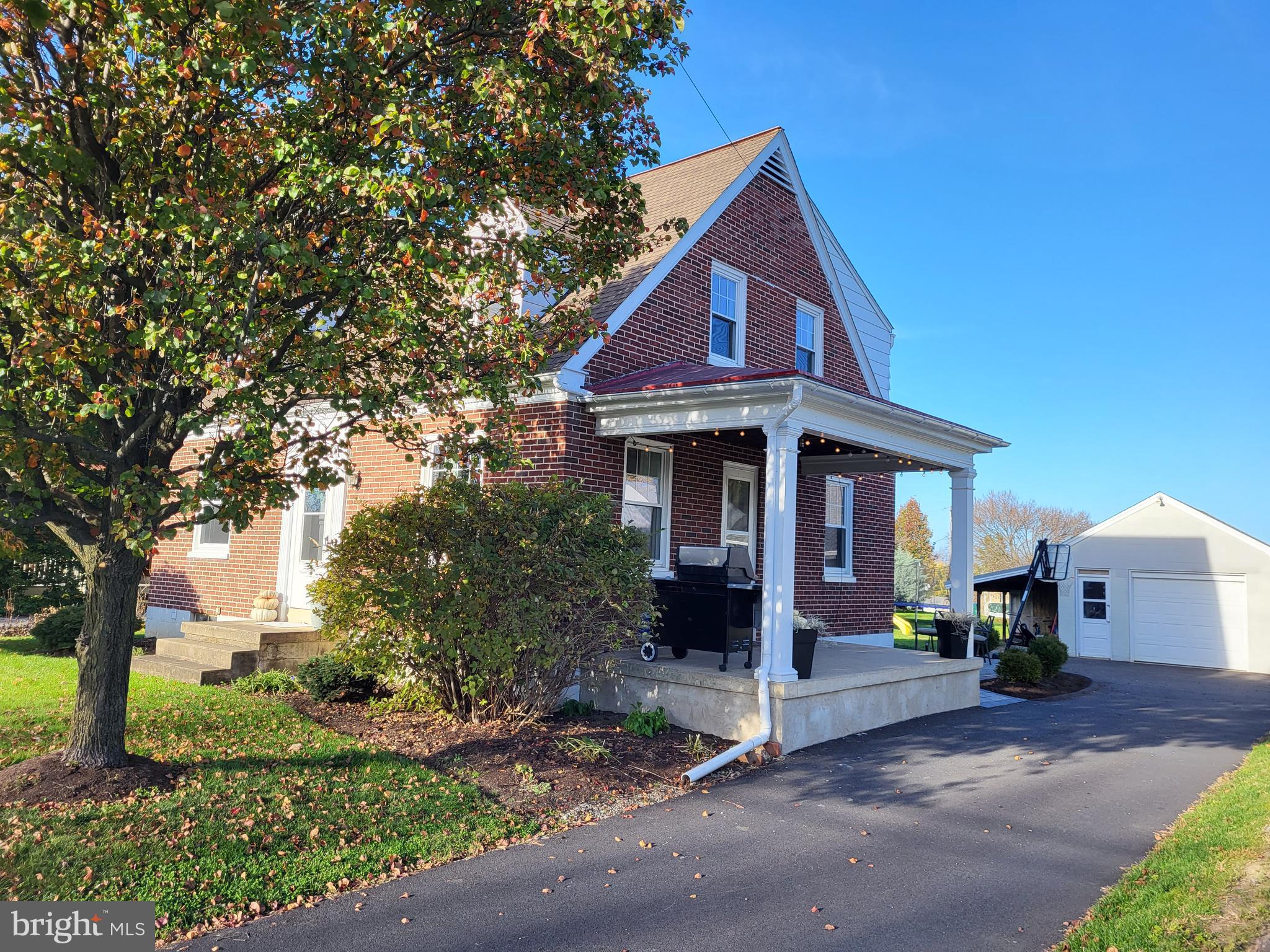 Come see this charming brick Cape Cod in Lampeter Strasburg school district!  This 3 bedroom 1.5 bath home has so much character and charm with beautiful hardwood floors throughout, original doors, and lots of cheery light.  As you enter the home from the lovely side porch, you'll find a cozy living room with open staircase to the second floor.  The kitchen has been remodeled with tile flooring, stainless steel appliances, white cabinets and concrete counter tops making it an enjoyable space in which to cook.  The dining room provides plenty of space to entertain and an extra room on the first floor serves as a family room/ play room or office.  Completing the main level is a nice half bath.  As you head upstairs, you'll arrive to a landing with a cedar closet for storing your extra clothes.  To the left is a full bath with subway tile shower and tile flooring. The 3 bedrooms all have hardwood floors and at least 2 windows bringing in the sunshine.  The basement provides extra storage and/or more room for the kids to play and space for finishing.  There is a bilco door allowing for items to easily be moved in or out of the basement.  
From the kitchen, venture out the back door onto the large, beautiful paver patio.  The backyard provides plenty of space for picnics, a garden, and for the dog to run.  The detached garage provides space for one car, a work bench, and a carport that will cover an additional small vehicle or bikes. This home is well maintained with all windows being replaced in 2017, central AC installed in 2015, Radon system installed 2017 and a newly paved driveway in 2022 among the updates. In addition, this home is located in a great community close to several parks and the community pool, the Strasburg Creamery, Village Greens mini golf and other restaurants in Strasburg. Schedule your showing right away; you won't want to miss this great home!